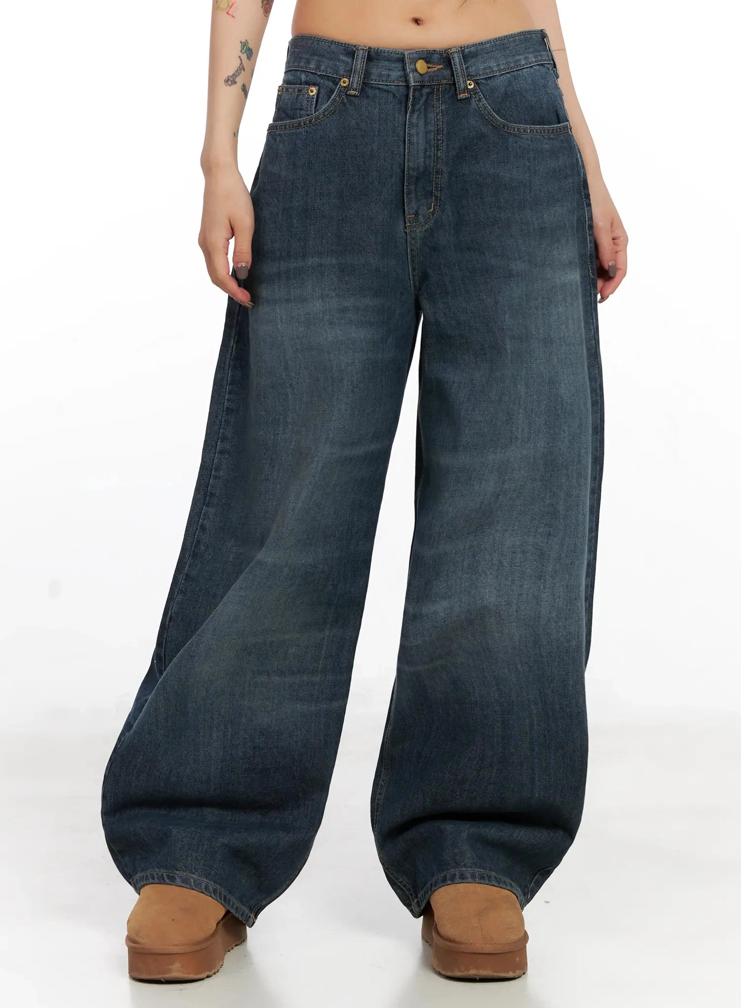 Regina Contrast Stitch Baggy Jeans IN528 in dark blue wash, cropped front view on model, wide baggy fit washed cotton denim with gold-tone hardware, front pockets and faded wash detailing visible.