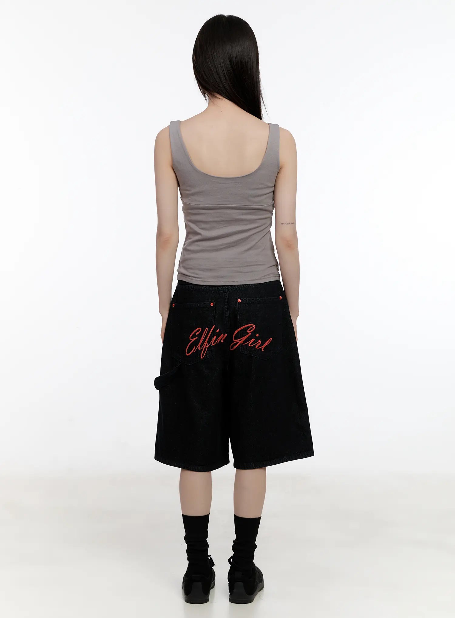 Red Text Graphic Embroidered Jorts CL504 in black, full back view on model, red 'Elfin Girl' embroidery, wide-leg loose fit, half length, styled with gray tank top.