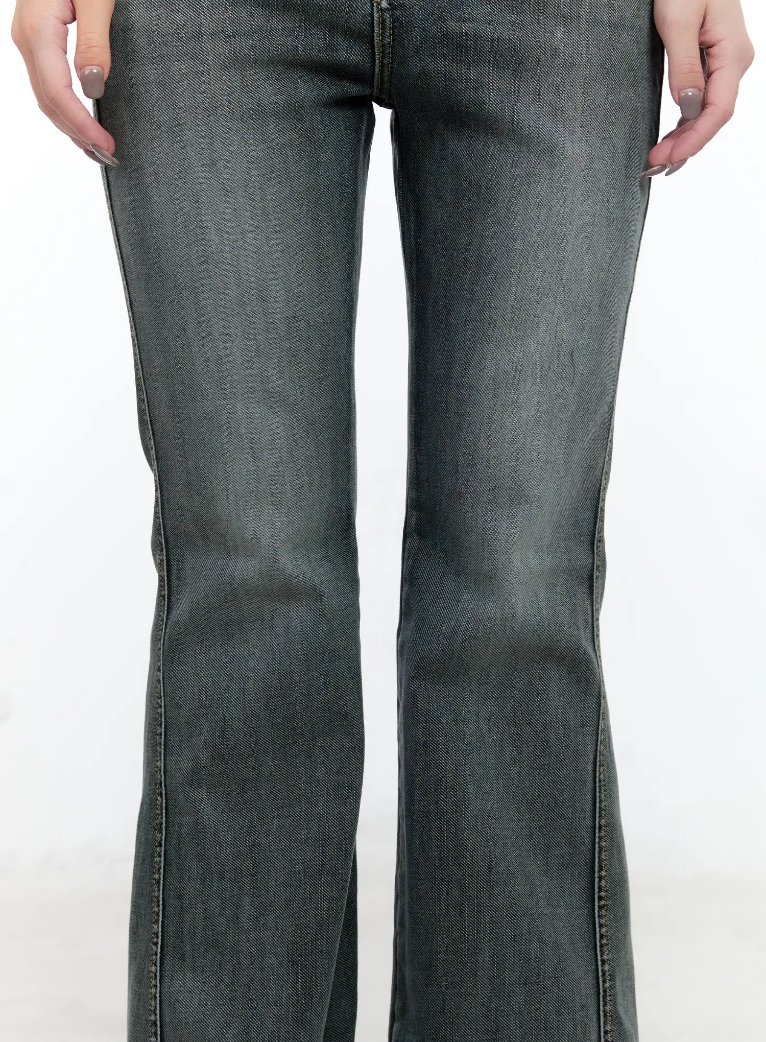 Judith Washed Bootcut Jeans CN517 in blue, front leg close-up on model, showing bootcut flare width from knee down, washed grey denim weave texture and center front seam detail.