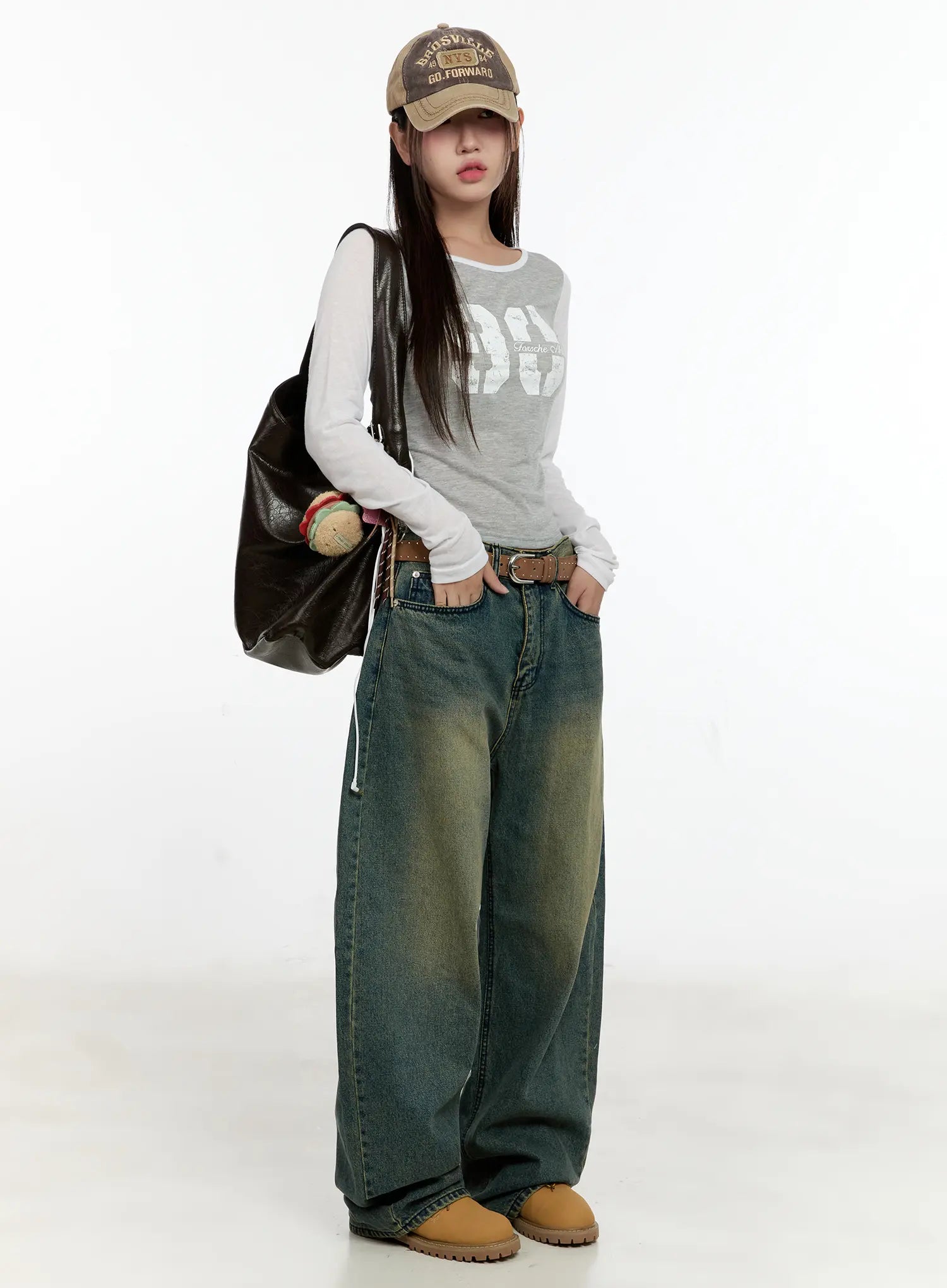 Sooyoung Baggy Vintage Wash Jeans CL531 in dark blue, full-body front on model with cap and large leather bag, baggy wide-leg vintage wash denim with belt, street casual styling.