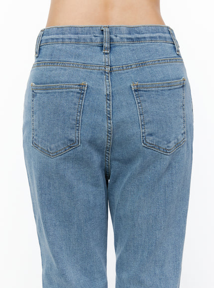 Leana Stretch Bootcut Jeans IU519 in blue, close-up back detail on model, two back pockets with contrast stitching, waistband seam, washed cotton-spandex denim texture.