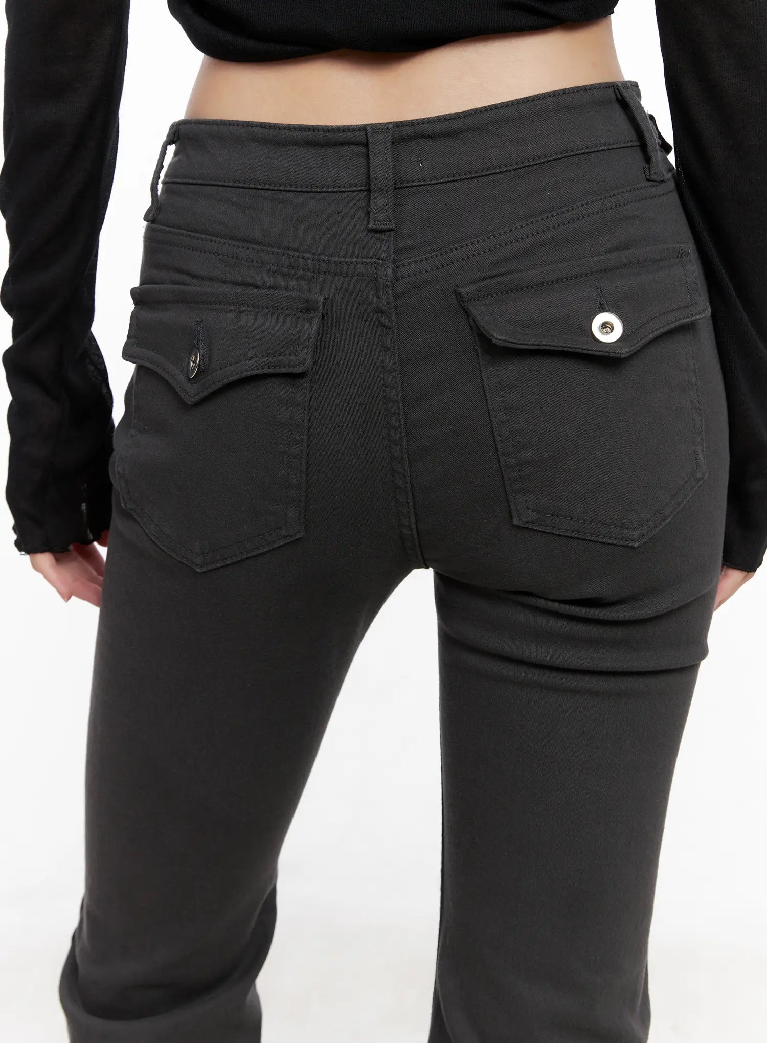 Addie Chic Flared Jeans CG522 in dark gray, back waist close-up on model, dual flap pockets with silver snap buttons, stitched pocket edges, solid cotton-spandex denim detail.