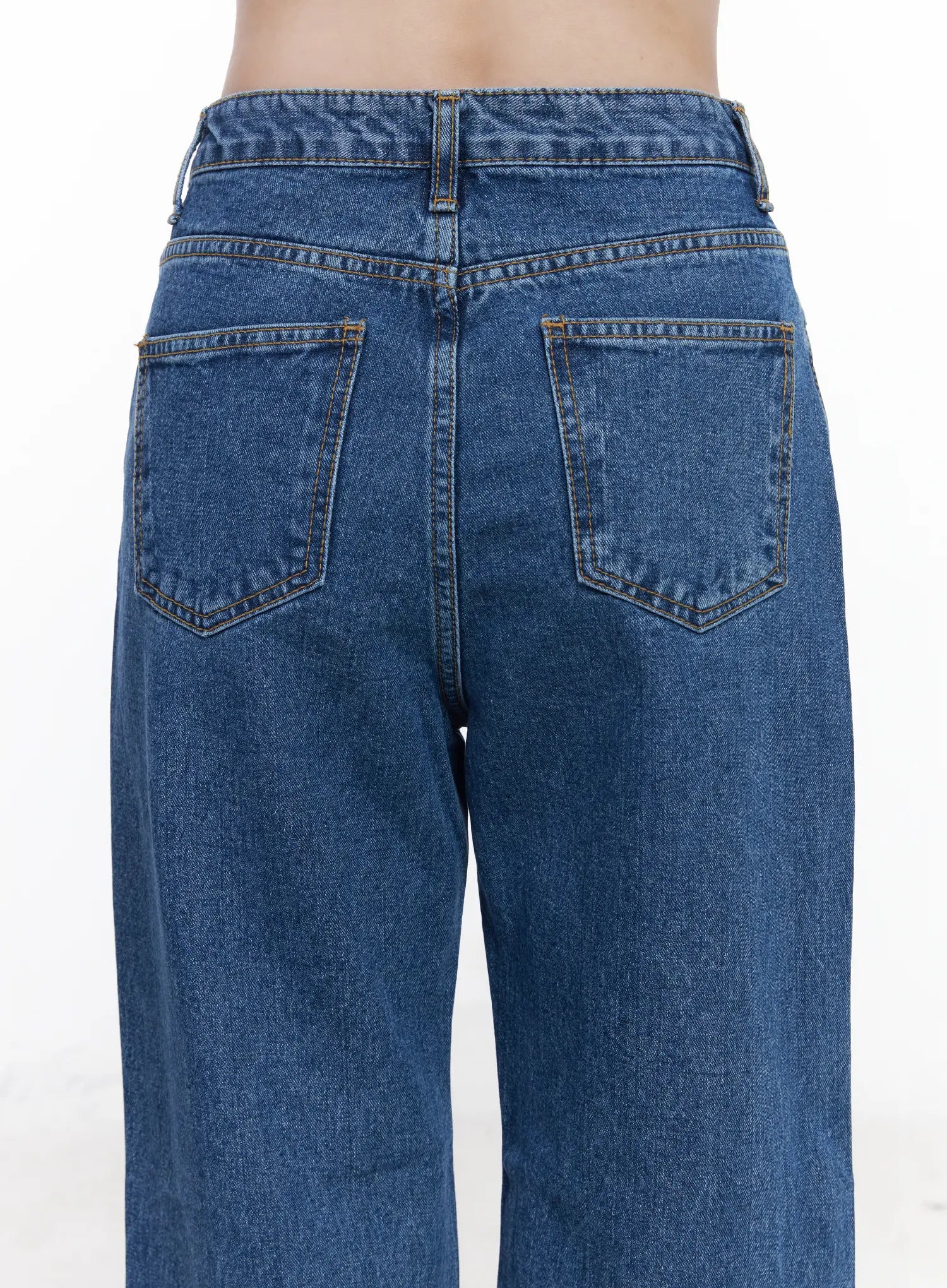 Aila Relaxed Fit Jeans CJ519 in blue, back waist close-up on model, dual back pockets with gold topstitching, high-rise waistband detail, washed cotton denim.