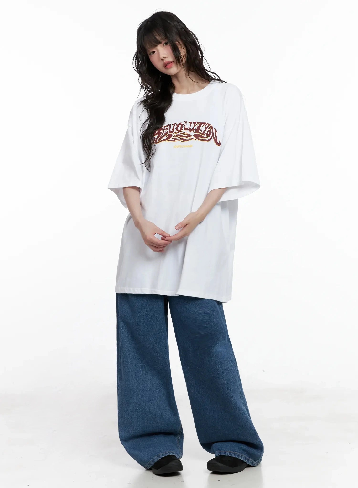 Pharita Loose-Fit Jeans IL528 in mid blue, full-body front shot on model paired with oversized white graphic tee, ultra-wide leg cotton denim in casual streetwear styling.