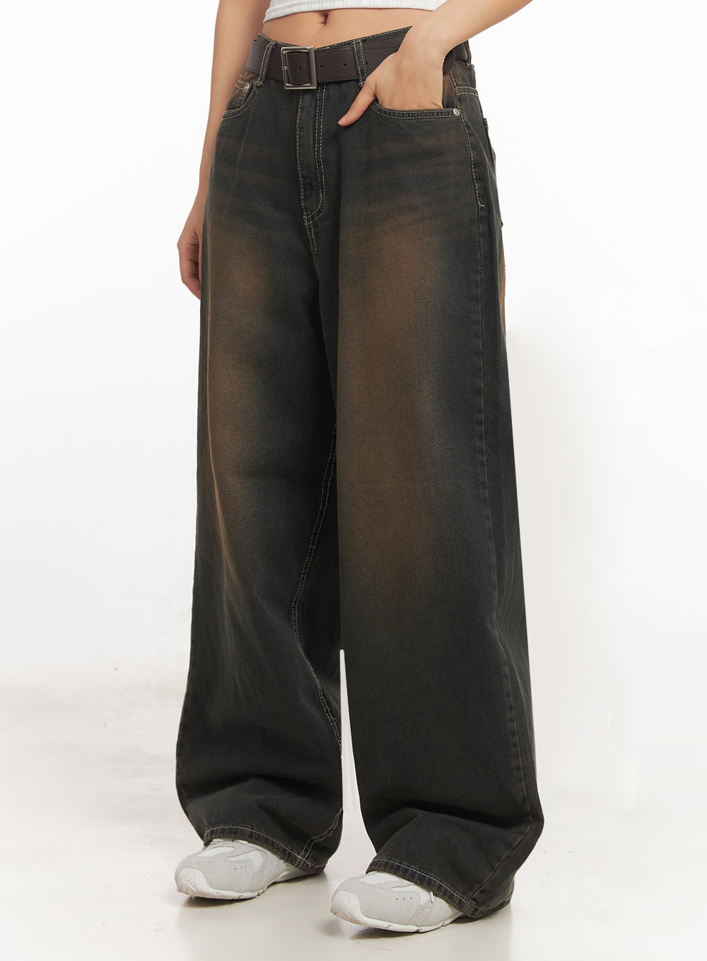 Bethany Vintage Washed Baggy Jeans IA524 in dark brown washed denim, front mid-shot close-up on model, showing wide-leg drape, contrast white stitching, brown fade wash, and brown belt detail at waist.