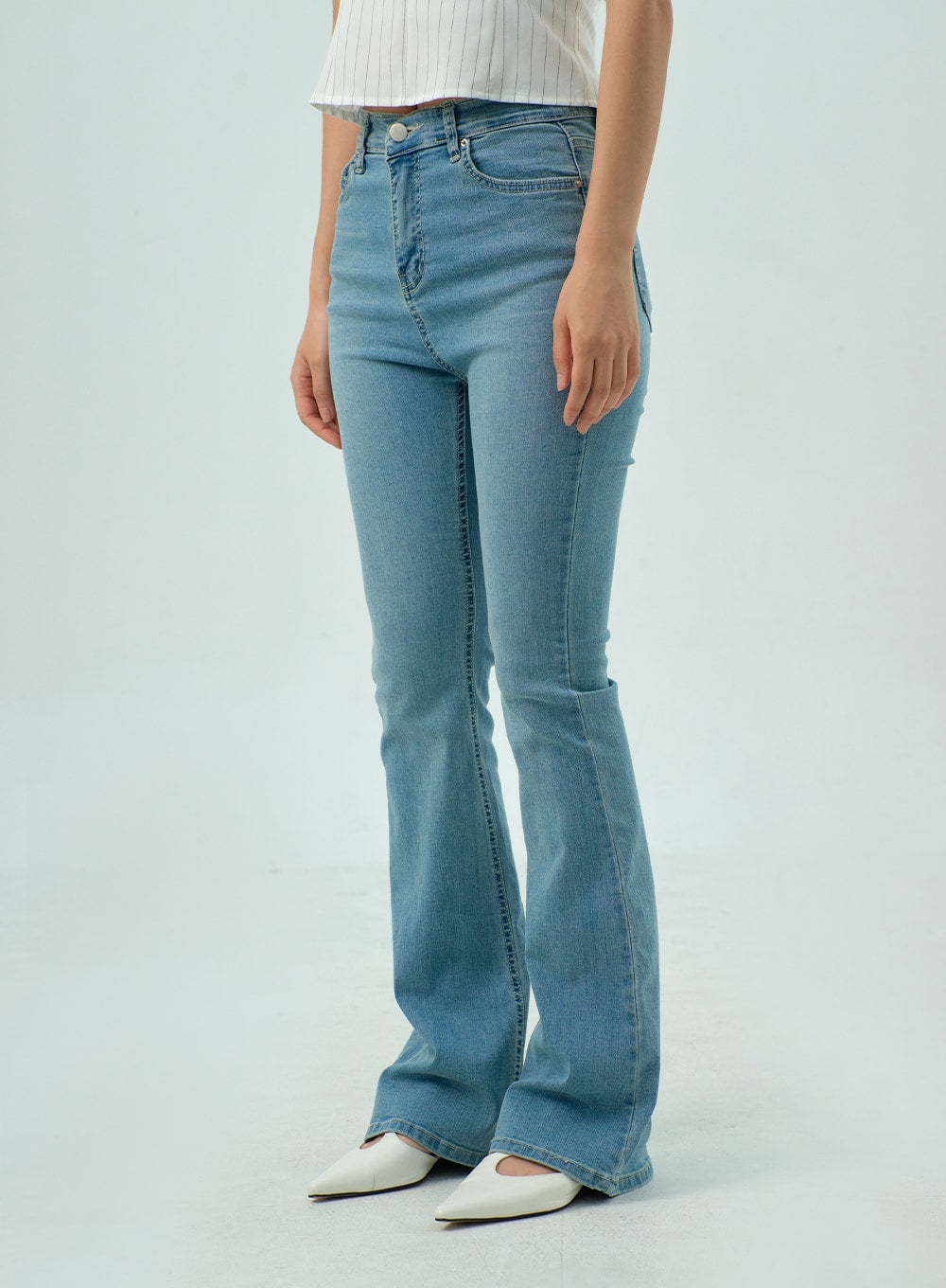 Light Wash Bootcut Jeans CY330 in light blue, side-front cropped view on model, high-rise waistband with coin pocket, slim fit through hip and thigh tapering into bootcut flare, washed denim texture.