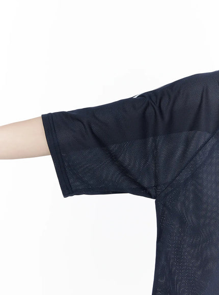 Oversized Sporty Graphic Tee CU519 in dark blue, macro detail close-up of sleeve and hem, honeycomb mesh fabric texture and white side stripe clearly visible, drop-shoulder cut.