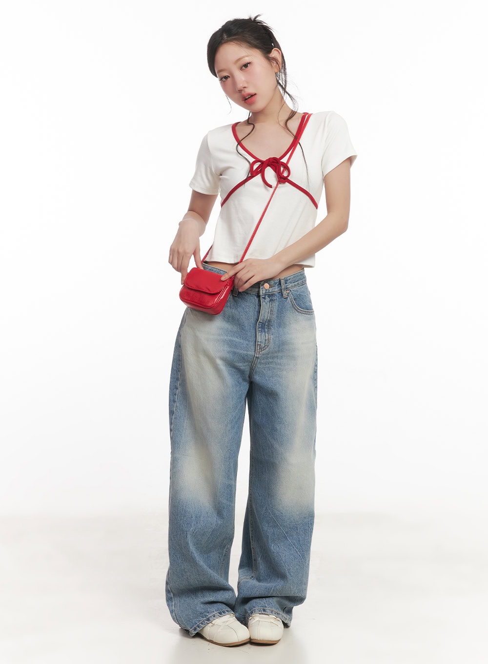 Lumira Back-Detail Washed Wide Leg Jeans CA530 in blue, full-length front view on model, wide-fit washed denim, styled with white bow-detail crop top and red mini crossbody bag.