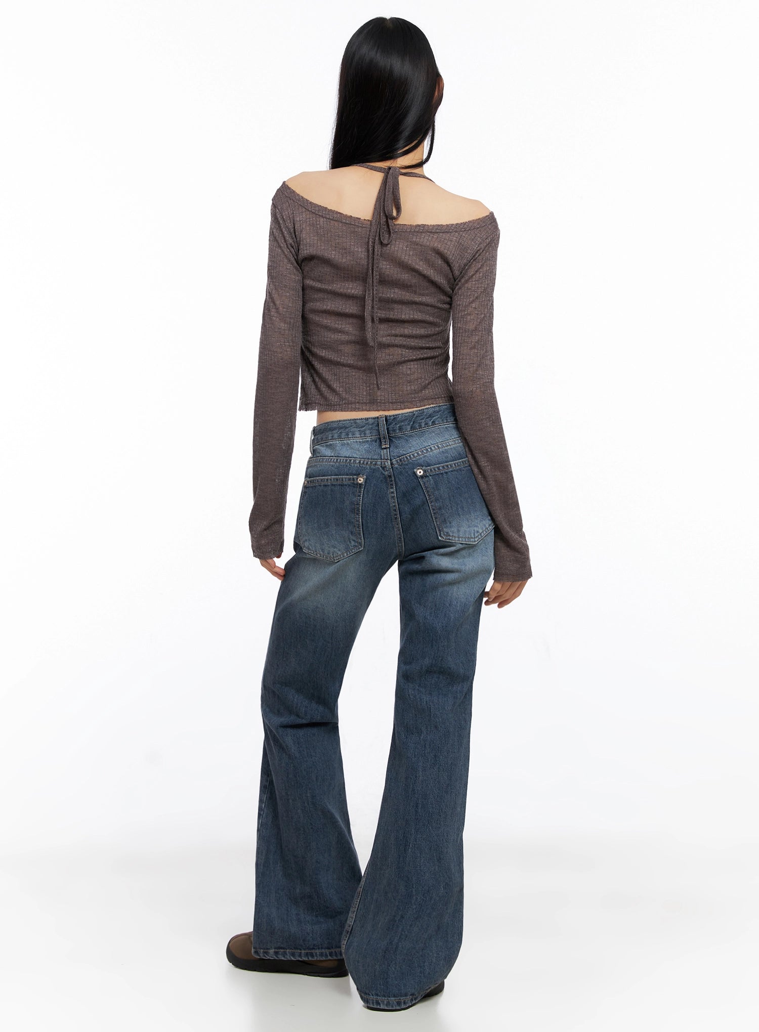 Myra Washed Bootcut Jeans IO516 in dark blue, back view on model, rear patch pockets with stitching detail visible, bootcut flare at hem, paired with brown off-shoulder knit top.