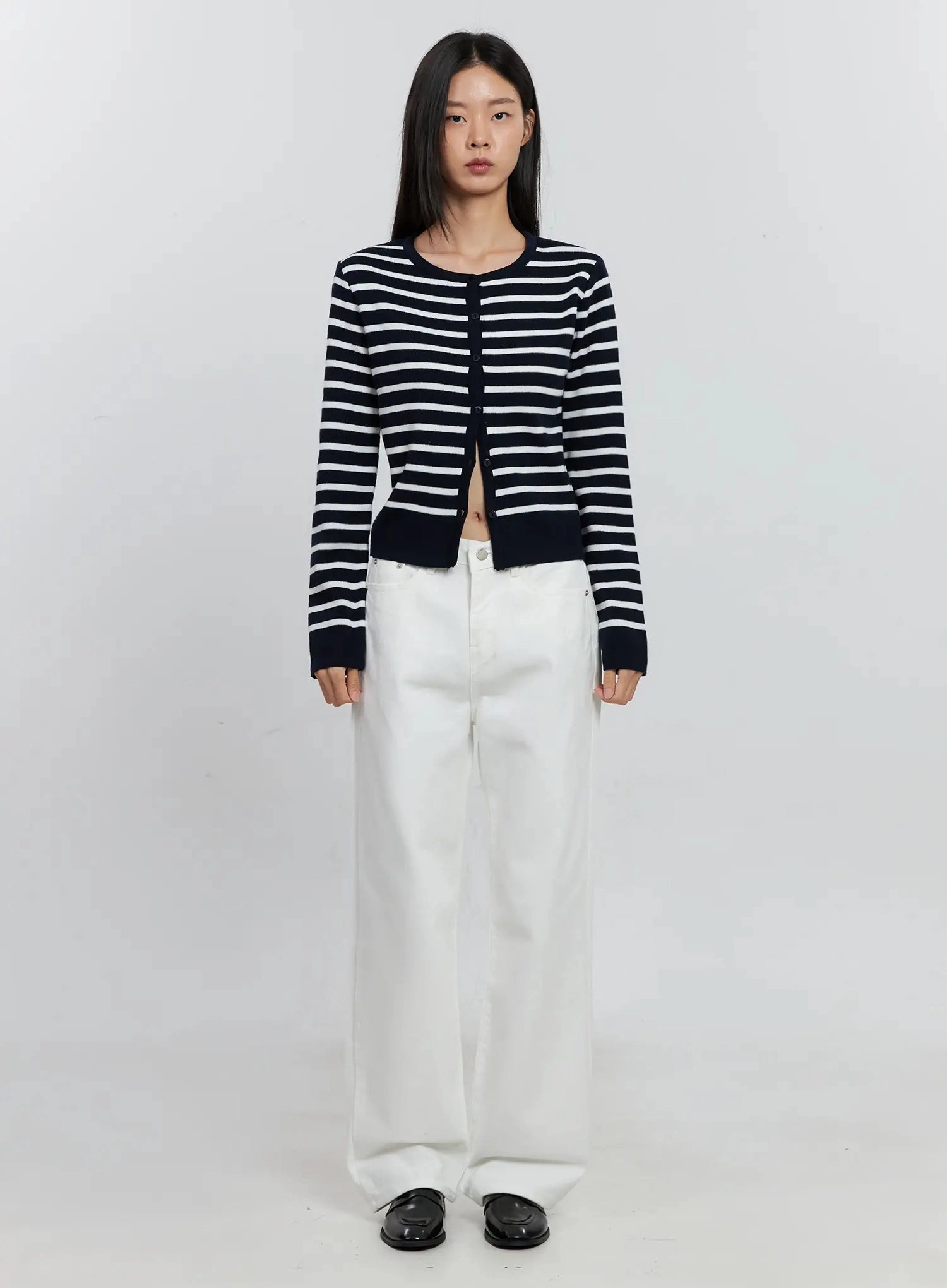 Taytum Straight-Leg Jeans IS515 in white, full-body front view on model standing straight, wide straight-leg cotton denim styled with navy stripe knit cardigan and black loafers.
