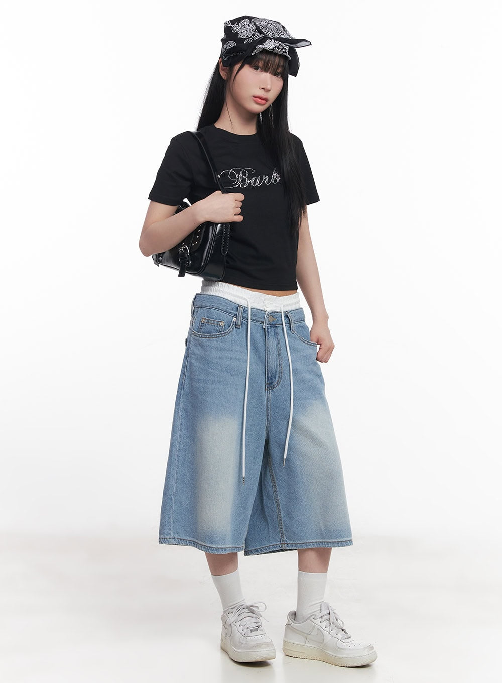 Layered Drawstring Baggy Jorts CY527 in light blue, three-quarter front on model, oversize washed denim jorts with white inner waistband and long drawstring, paired with black crop tee, bandana, and black crossbody bag.