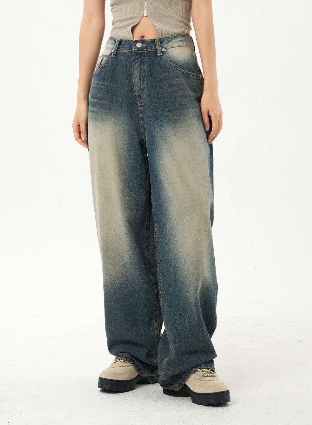 Mid-Rise Baggy Jeans CA325 in vintage blue denim, front waist-to-ankle close-up on model, mid-rise waistband detail with belt loops and pronounced yellow-to-blue faded wash on baggy leg.
