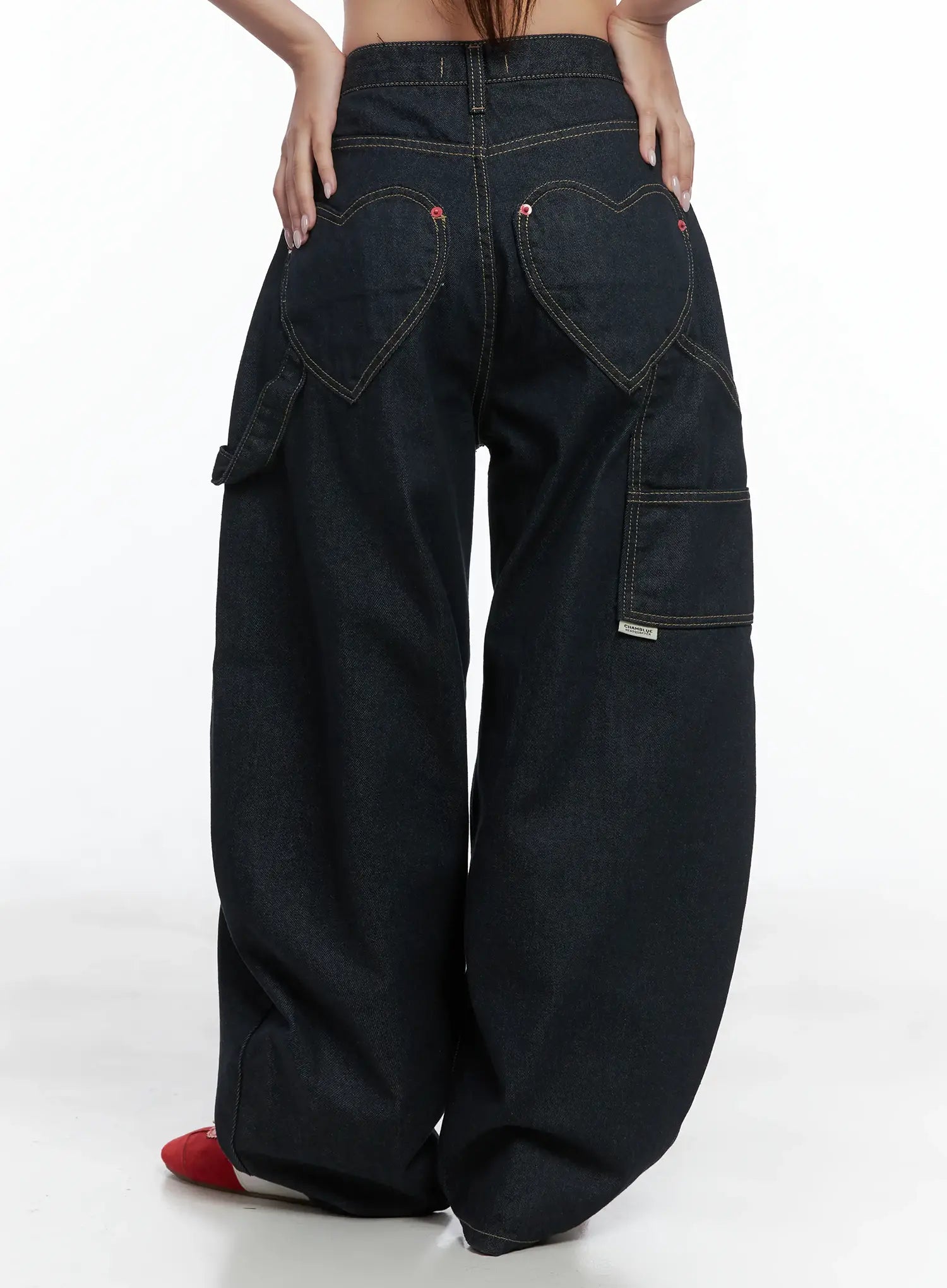Heart Pocket Balloon Jeans CS503 in dark indigo, full back view on model, heart-shaped back pockets with yellow stitching, side cargo pocket with brand label, balloon wide-leg length.