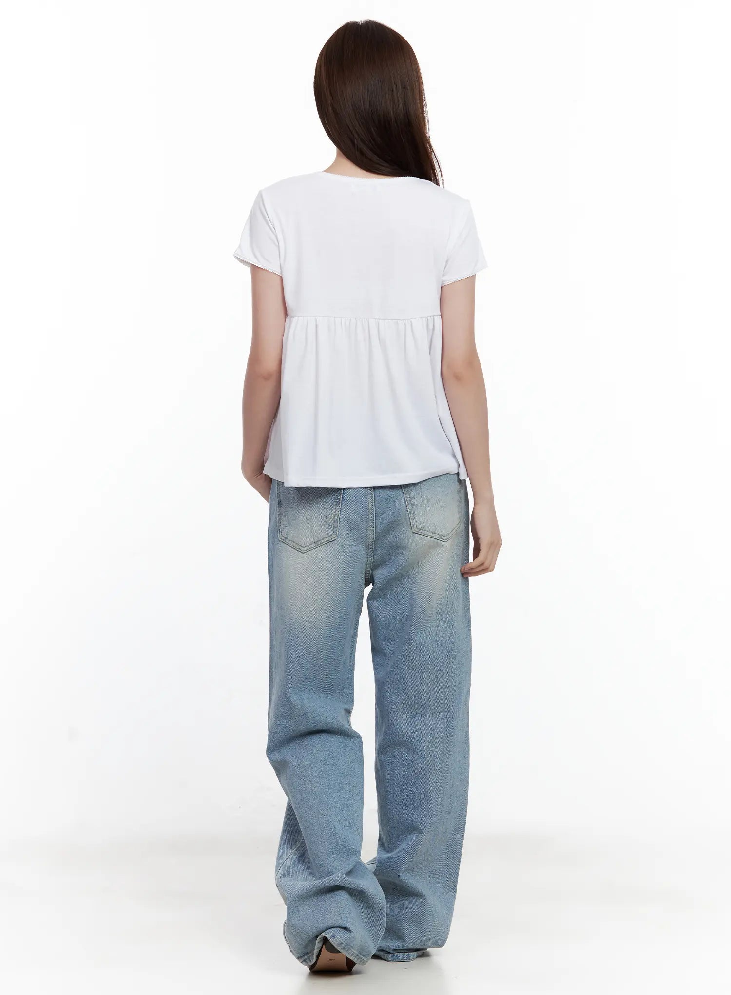 Ina Slouchy Fit Jeans CL502 in blue, back full-body view on model, wide slouchy washed denim with back pockets visible, hem stacking at floor, paired with white babydoll tee.
