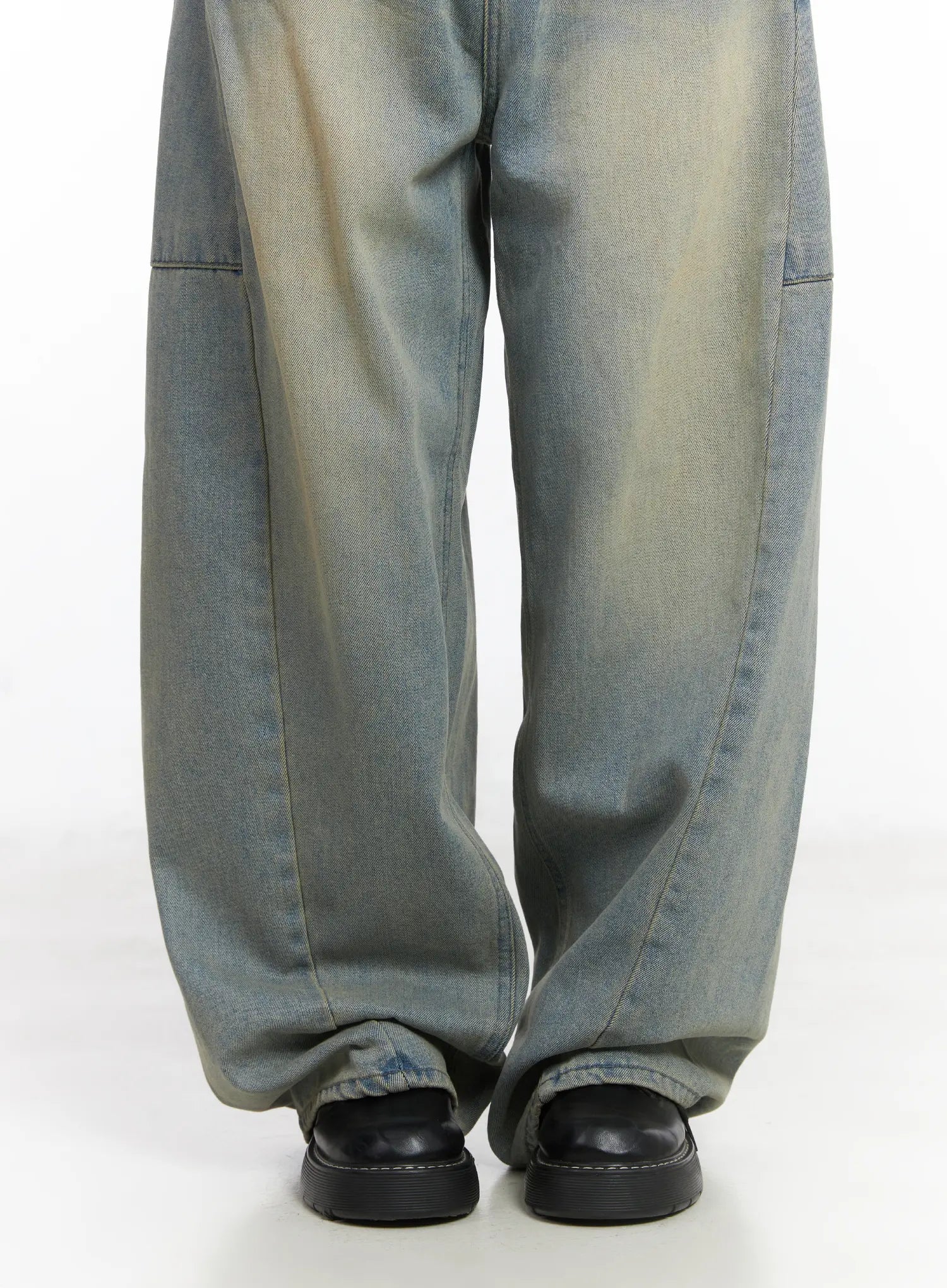 Lyla Washed Wide Leg Jeans CD530 in light blue, lower-leg close-up on model, extra-wide hem pooling over black loafers, washed cotton denim with visible panel seam and faded finish.