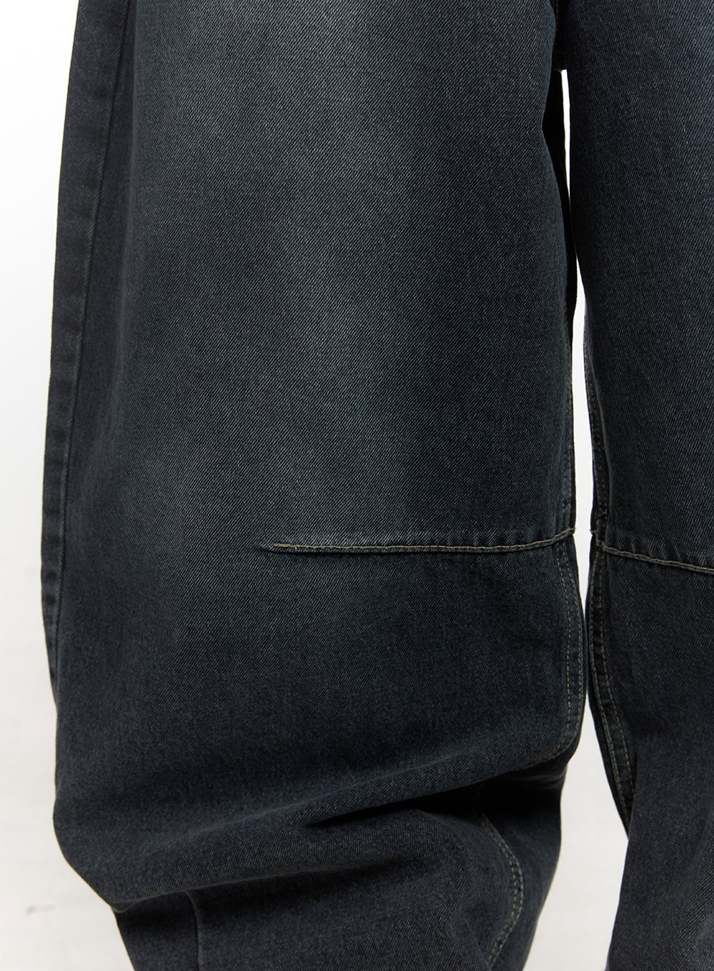Giselle Stitched Balloon-Fit Jeans CF526 in dark blue, macro close-up of thigh panel stitch detail, revealing twill denim weave texture and precise contrast seam construction.