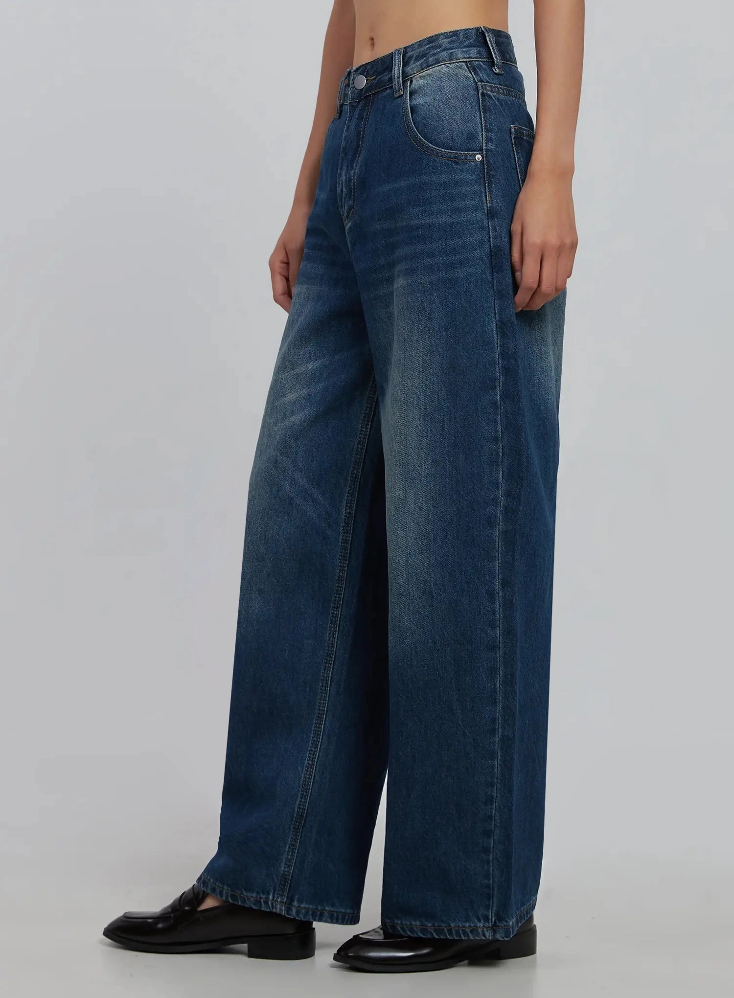 Alaina Wide Leg Jeans IJ508 in dark blue, side close-up on model, wide-leg silhouette with visible side seam and washed cotton texture, mid-rise waist, loafers.