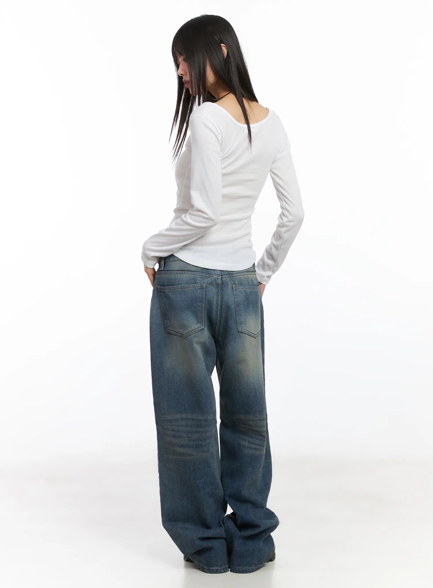 Miriam Wide Leg Jeans CD519 in blue, back full-length on model, back pockets and heavy washed fading across seat and knees shown, paired with white fitted long-sleeve top.