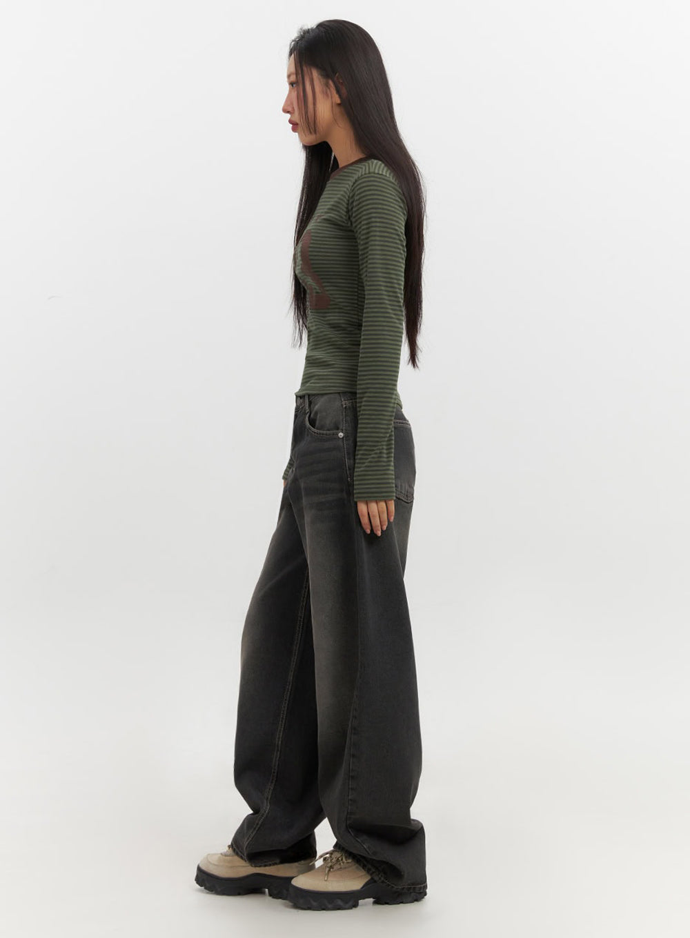 Skyla Washed Wide-Leg Baggy Jeans IF511 in washed black, side full-body shot on model, profile view showing balloon silhouette, wide-leg hem pooling over chunky sneakers, with striped top.