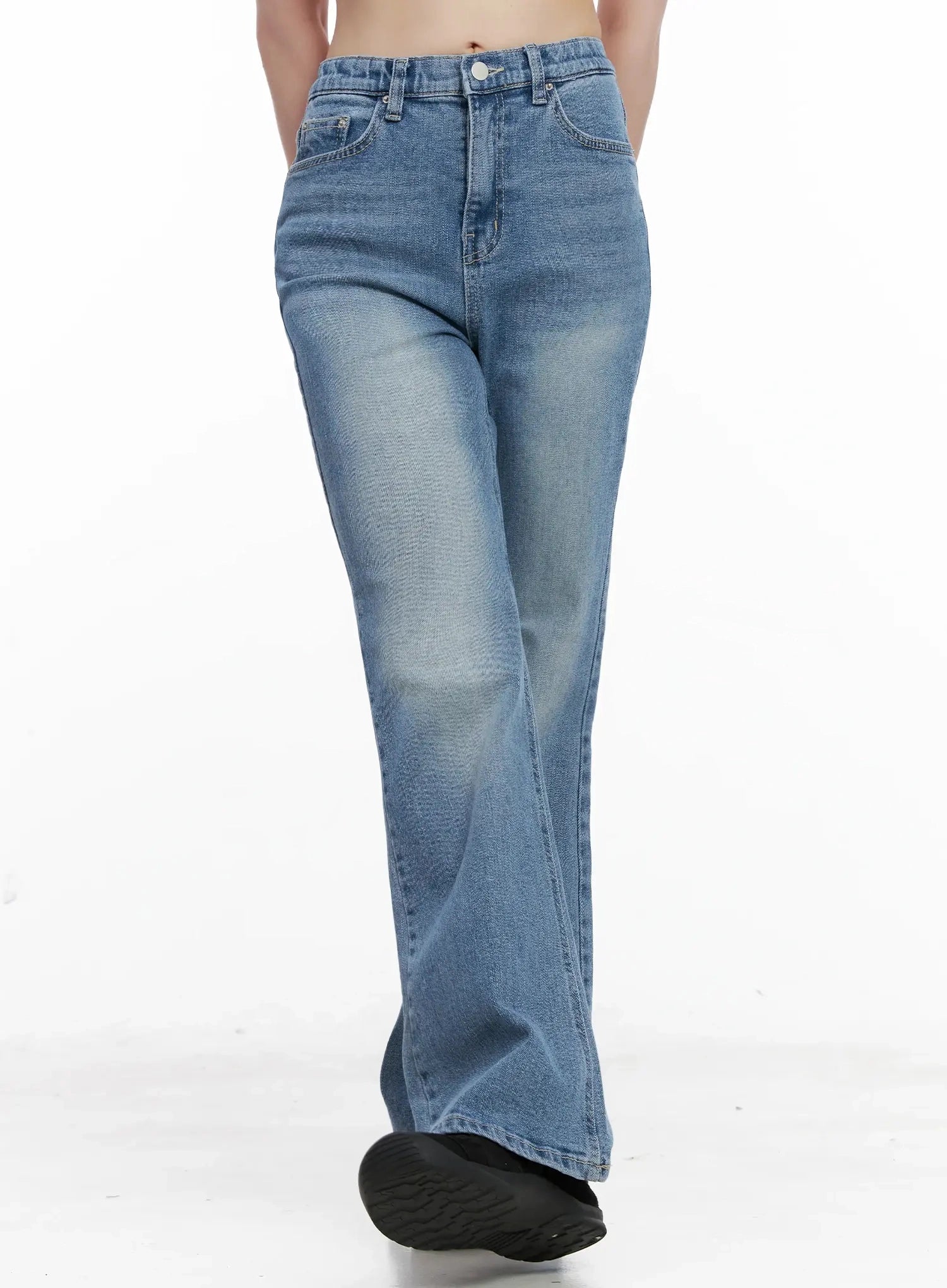 Hikaru High-Waist Flare Jeans IL531 in blue, front walking shot on model, slight motion showing flare leg sweep, washed denim with fade detail, high-waist button fly.