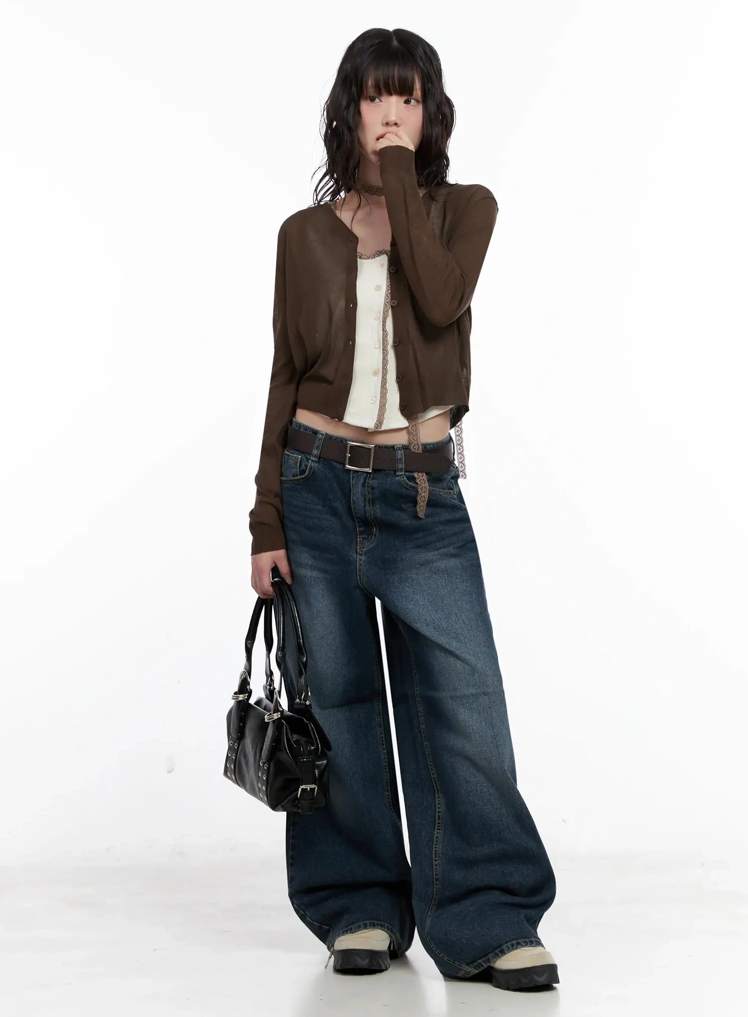 Mashiro Vintage-Wash Wide Jeans IL531 in dark blue, full-length standing shot on model holding black leather bag, wide-leg washed cotton denim with belt, layered with brown cardigan and white lace cami.
