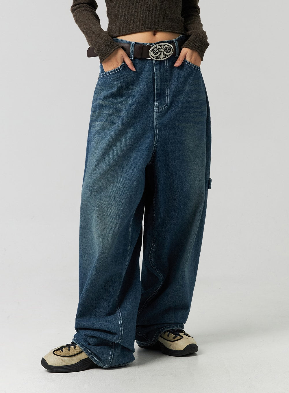 Washed Cotton Wide Leg Jeans CO323 in blue, front hip-to-hem shot on model, hands in waistband, carpenter-detail seam on thigh, heavy washed cotton denim with voluminous wide leg.