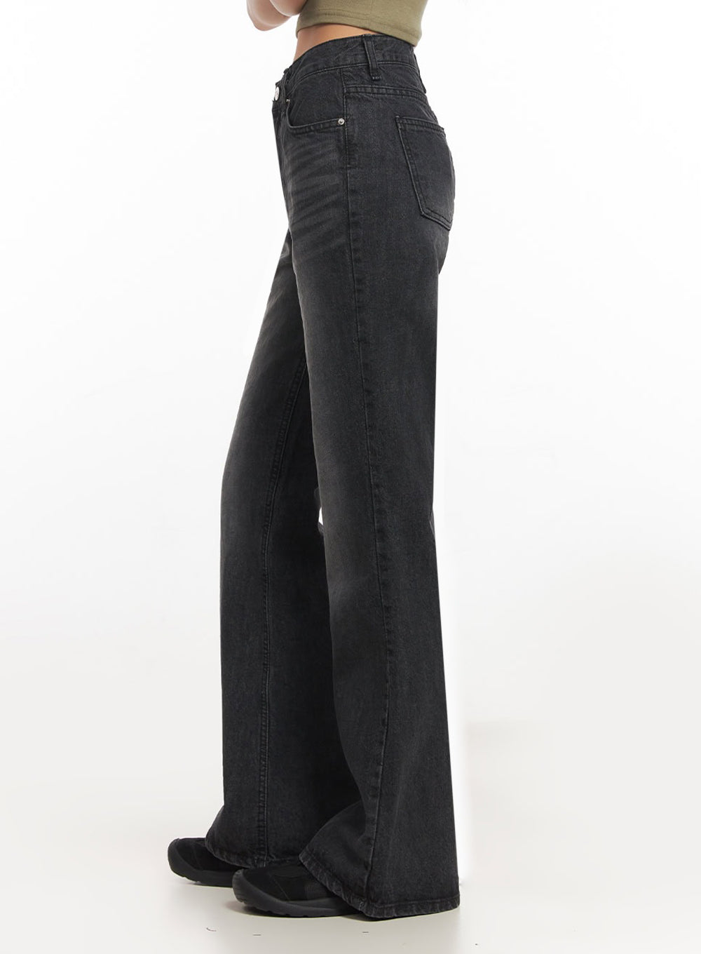 Joanna Washed Flared Jeans IA504 in washed black, side close-up from waist to hem on model, high-rise slim silhouette, clean side seam flaring below knee, front coin pocket detail visible.