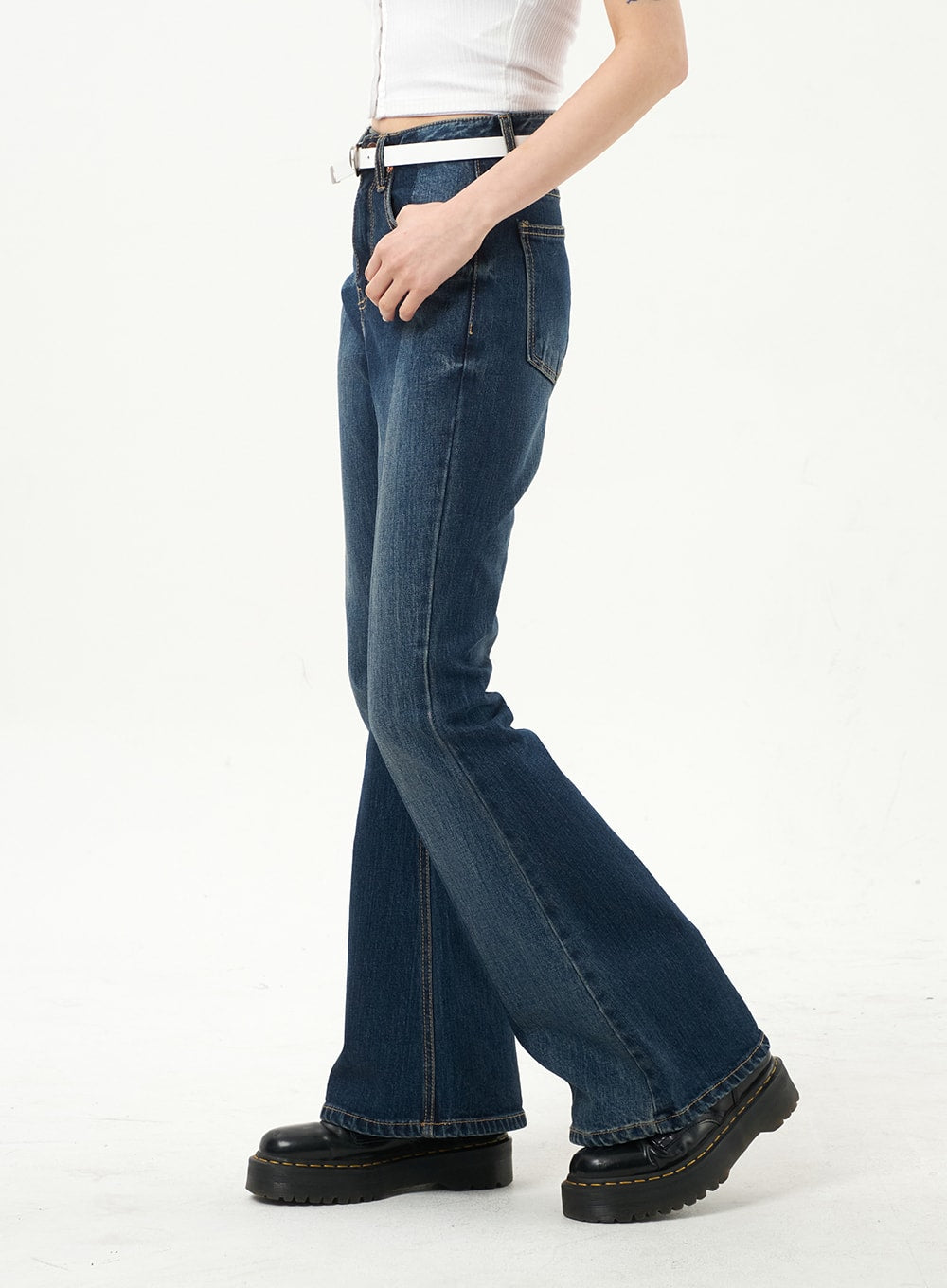 Dark Wash Bootcut Jeans CA328 in dark blue, direct side view on model, highlighting slim thigh-to-knee fit and wide bootcut flare, contrast stitching and white belt.