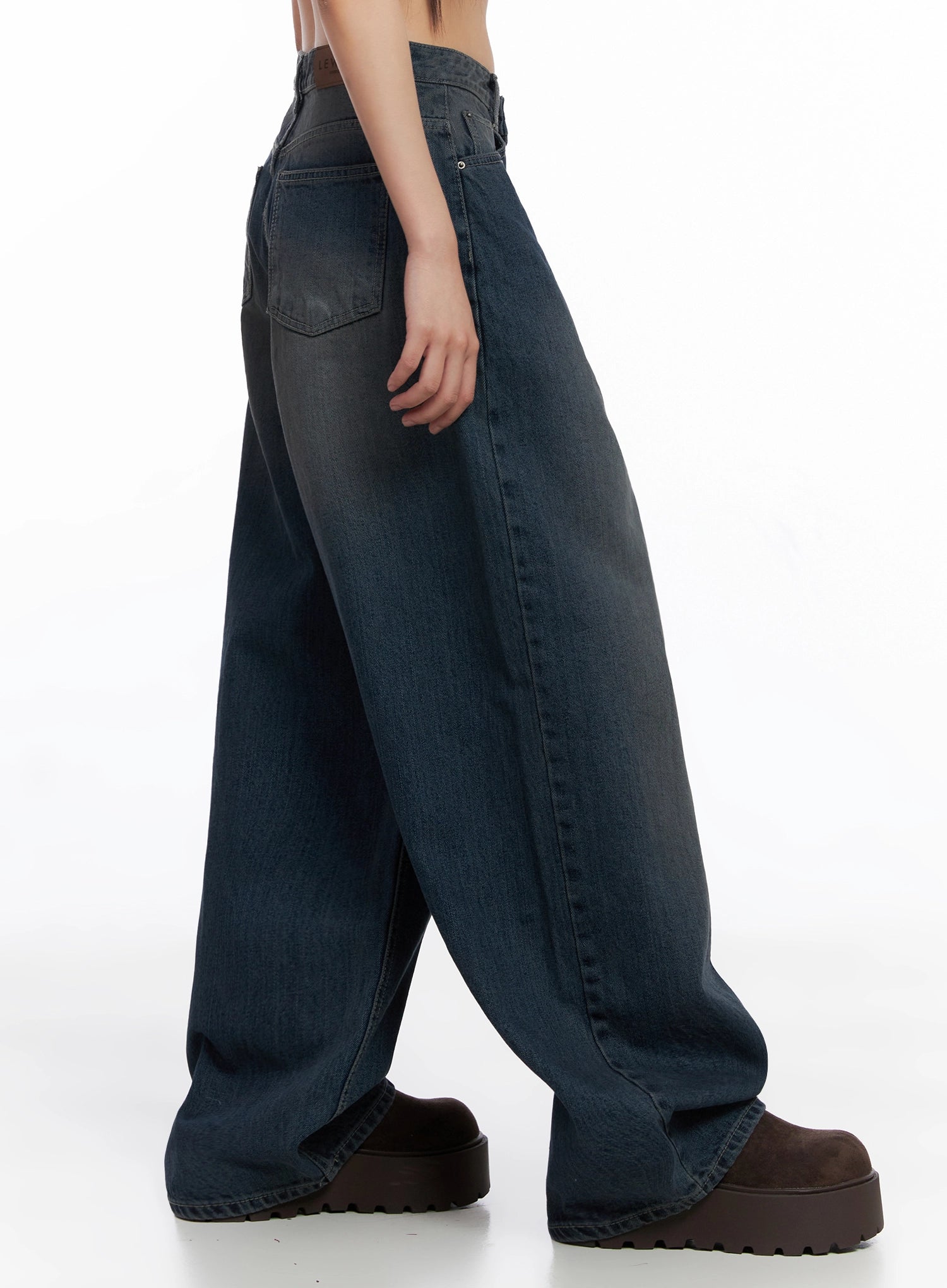 Adelyn Washed Baggy Jeans IS525 in dark blue, side profile shot on model, showing back pocket placement, washed denim fade from waist to hem, and extreme wide-leg silhouette.