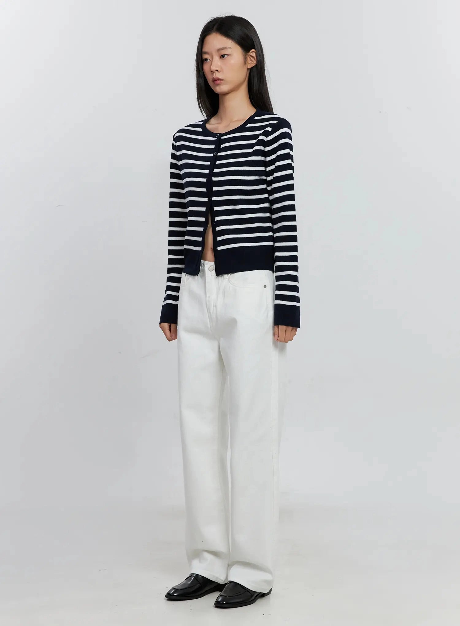 Taytum Straight-Leg Jeans IS515 in white, three-quarter angled front view on model, straight-leg cotton denim with silver rivets, styled with navy striped cardigan and black mules.