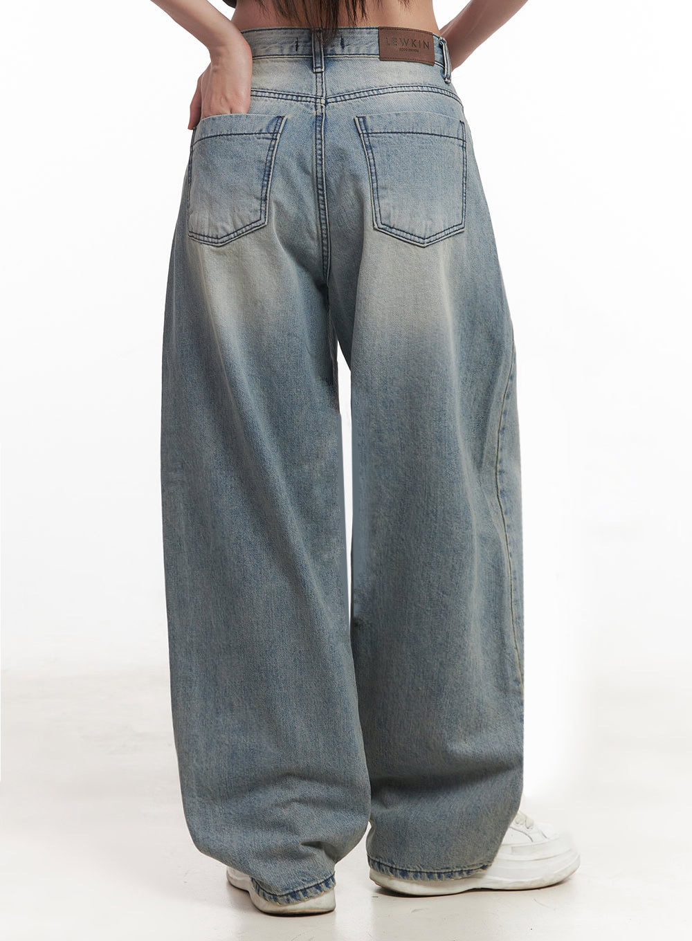 Casey Washed Baggy Jeans IM528 in light blue, back view from waist to hem on model, two back patch pockets with LEWKIN leather logo label, washed fading across seat and leg, ultra-wide silhouette.