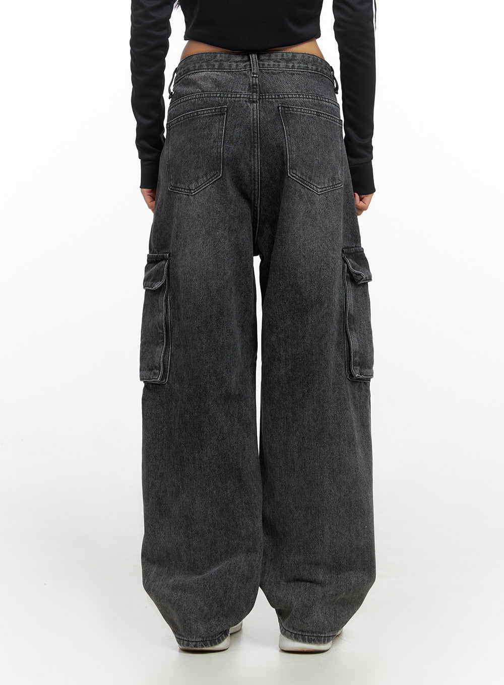 Neve Washed Cargo Denim Jeans IS427 in washed black, back waist-to-hem close-up on model, showing rear yoke, two back pockets, and back-thigh cargo flap pockets on wide cotton denim legs.