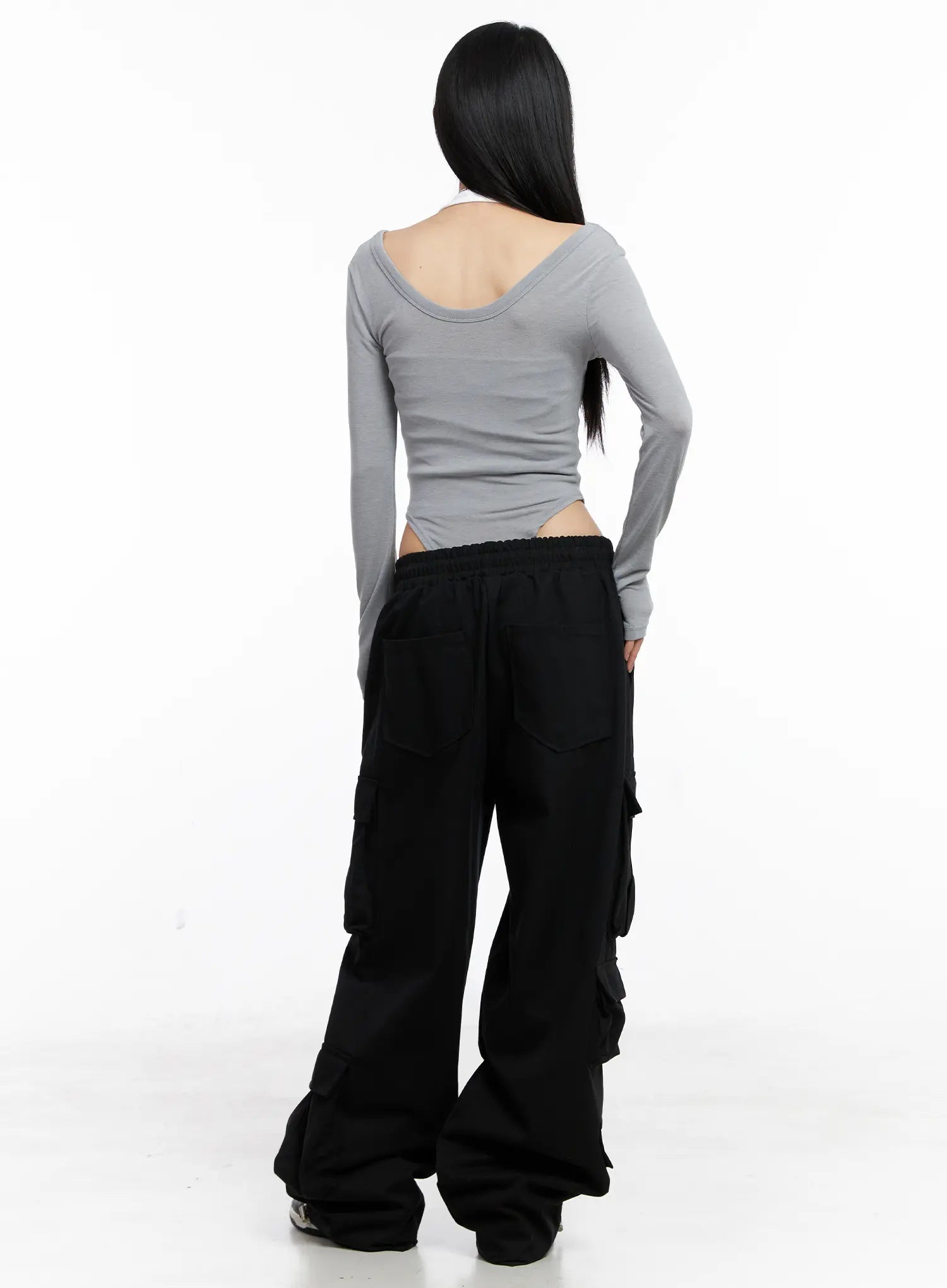 Wide Leg Cargo Pants CC1109 in black, back full-body shot on model, elastic drawstring waist, oversized wide leg stacking at hem, paired with grey scoop-back crop top.