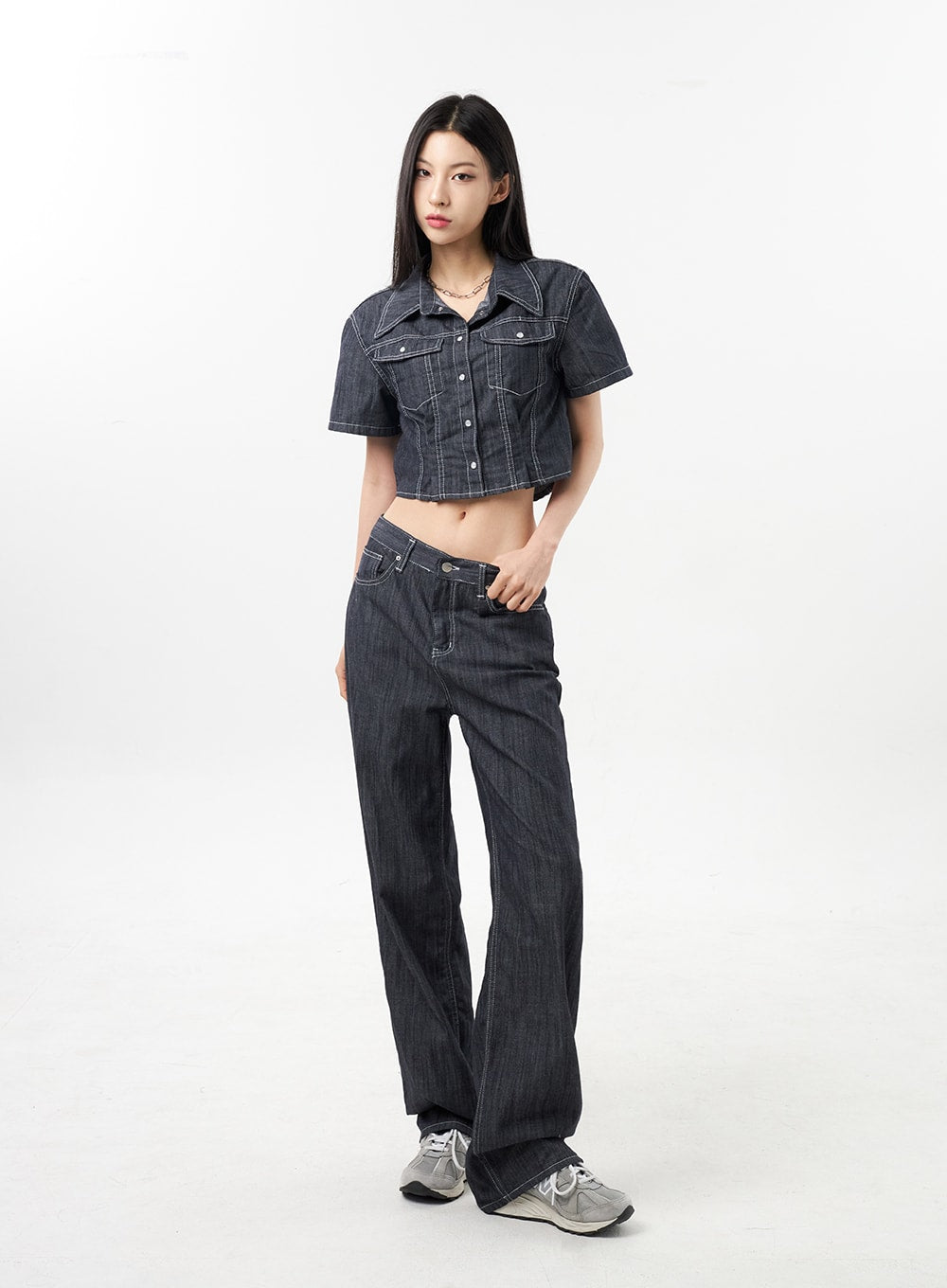 Low Rise Wide Pants CU312 in dark grey, full-length three-quarter front view on model, low-rise waistband and wide-leg cotton-poly denim, one hand in pocket, worn with matching denim set.