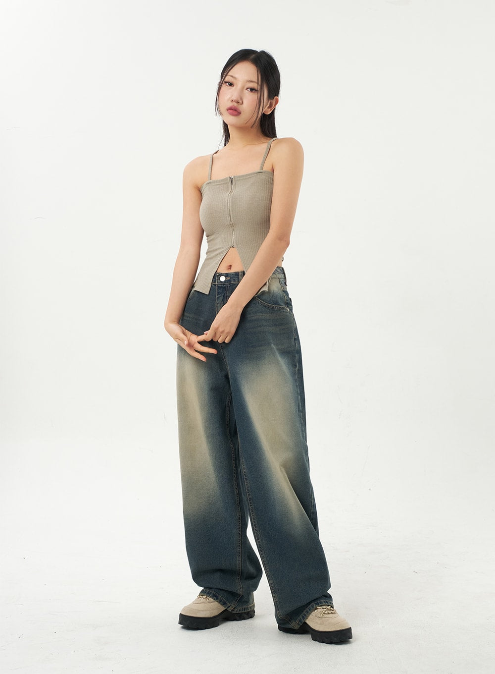 Mid-Rise Baggy Jeans CA325 in vintage blue denim, full-length front view on model with slight side turn, oversized wide-leg silhouette with gradient fading, styled with beige ribbed cami top.