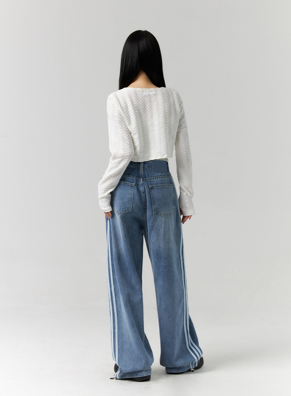 Side Stripes Wide Leg Jeans CS314 in blue, full back view on model, showing dual white side stripes, back pockets, and high-rise waistband on wide-leg washed denim.