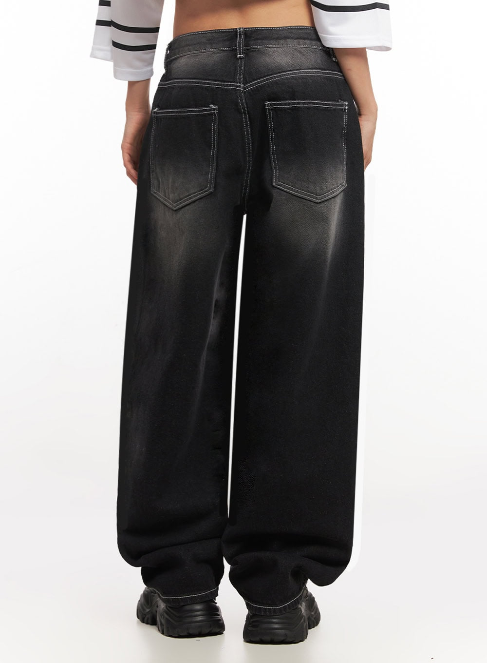 Alexis Stitched Wide-Leg Jeans IA504 in washed black, back waist-to-hem close-up on model, featuring dual back pockets with contrast white topstitching and faded wash detail on wide-fit denim.