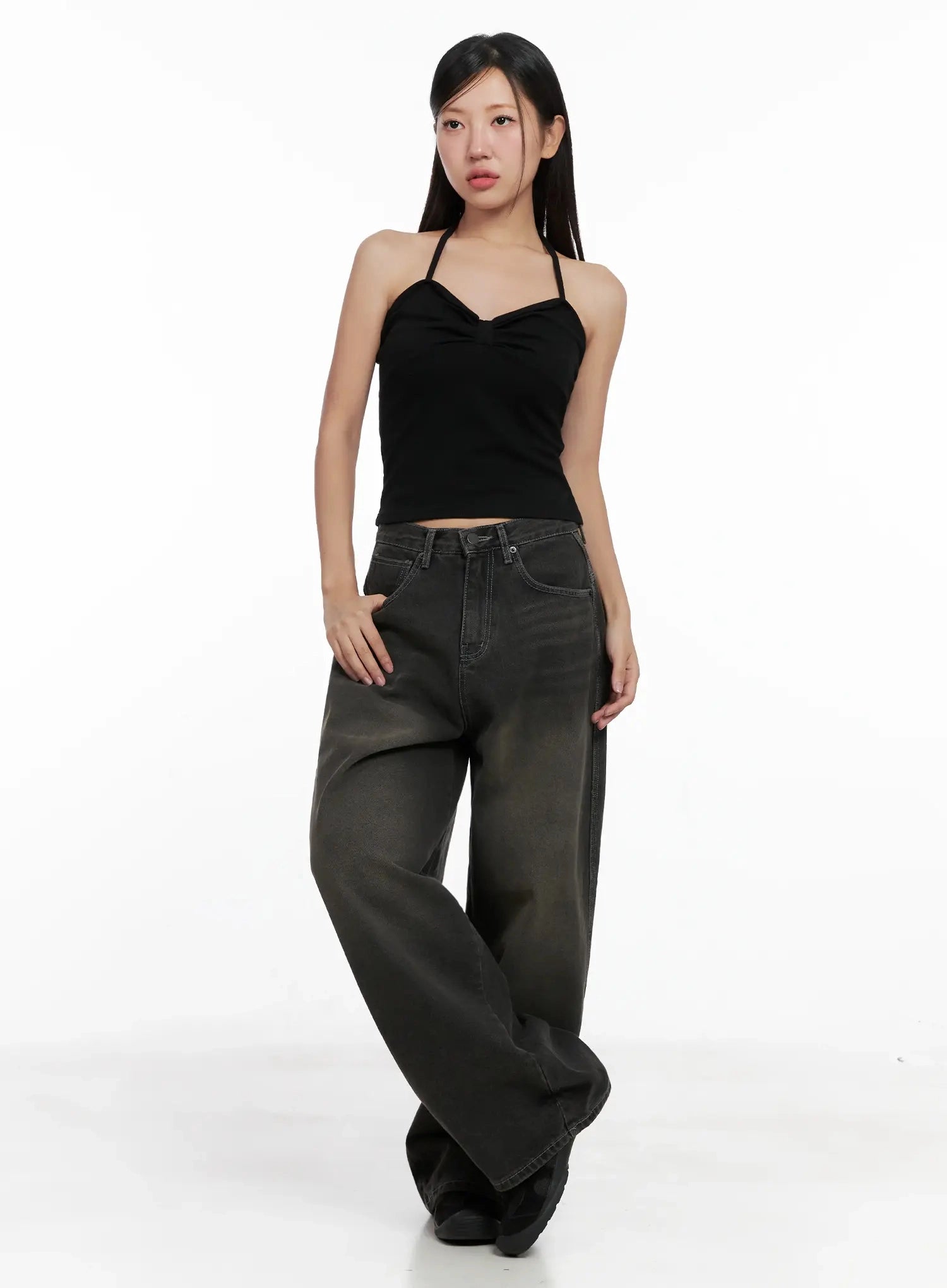 Hari Dark Washed Baggy Jeans IG527 in dark grey, full-length front shot on model, wide baggy fit with dark washed fading, paired with black halter crop top, hand resting on pocket.