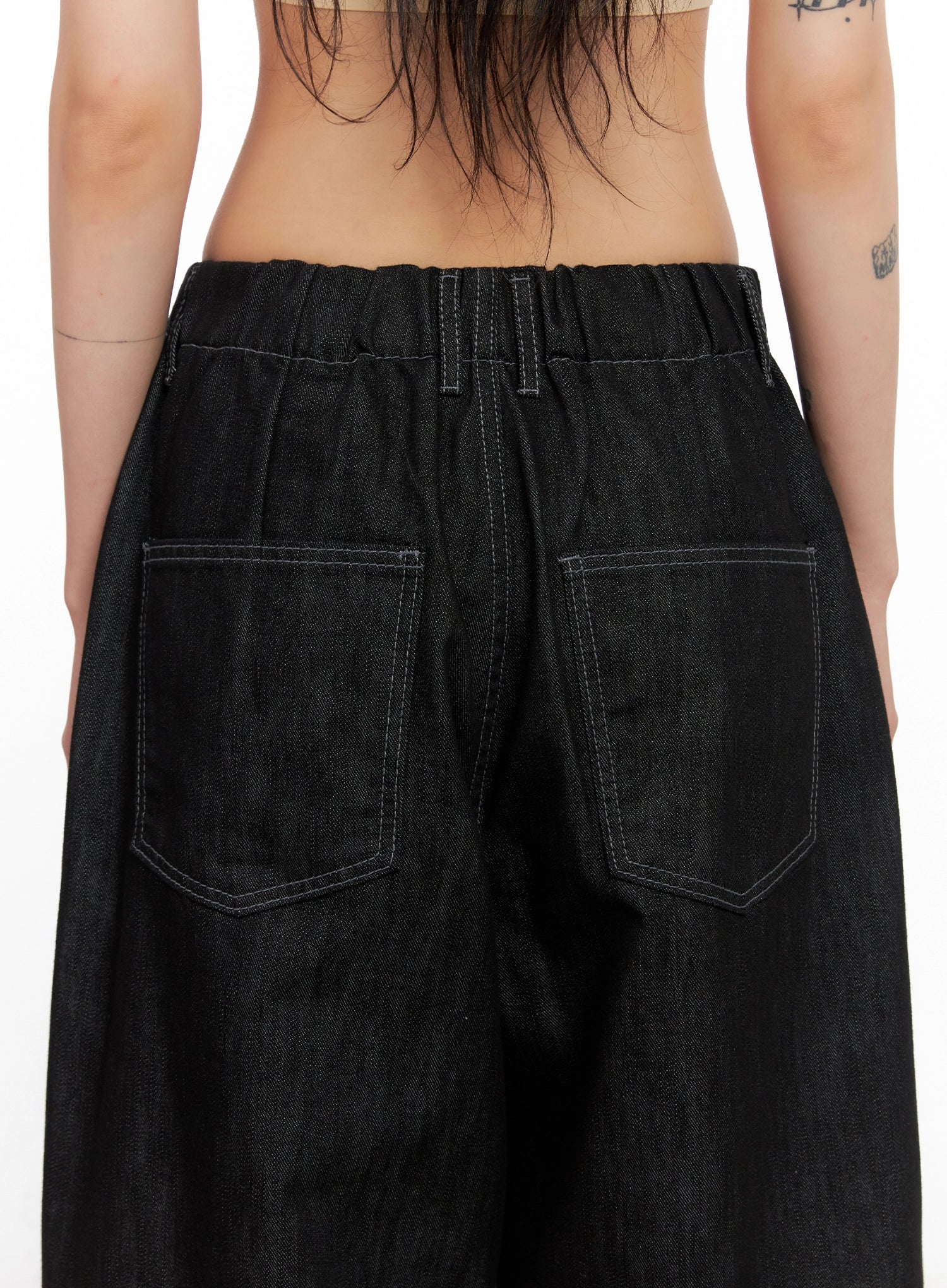Leyla Pin-Tuck Wide-Leg Jeans IS515 in black, close-up back detail on model, elastic waistband and square patch pockets with contrast topstitching on denim texture.