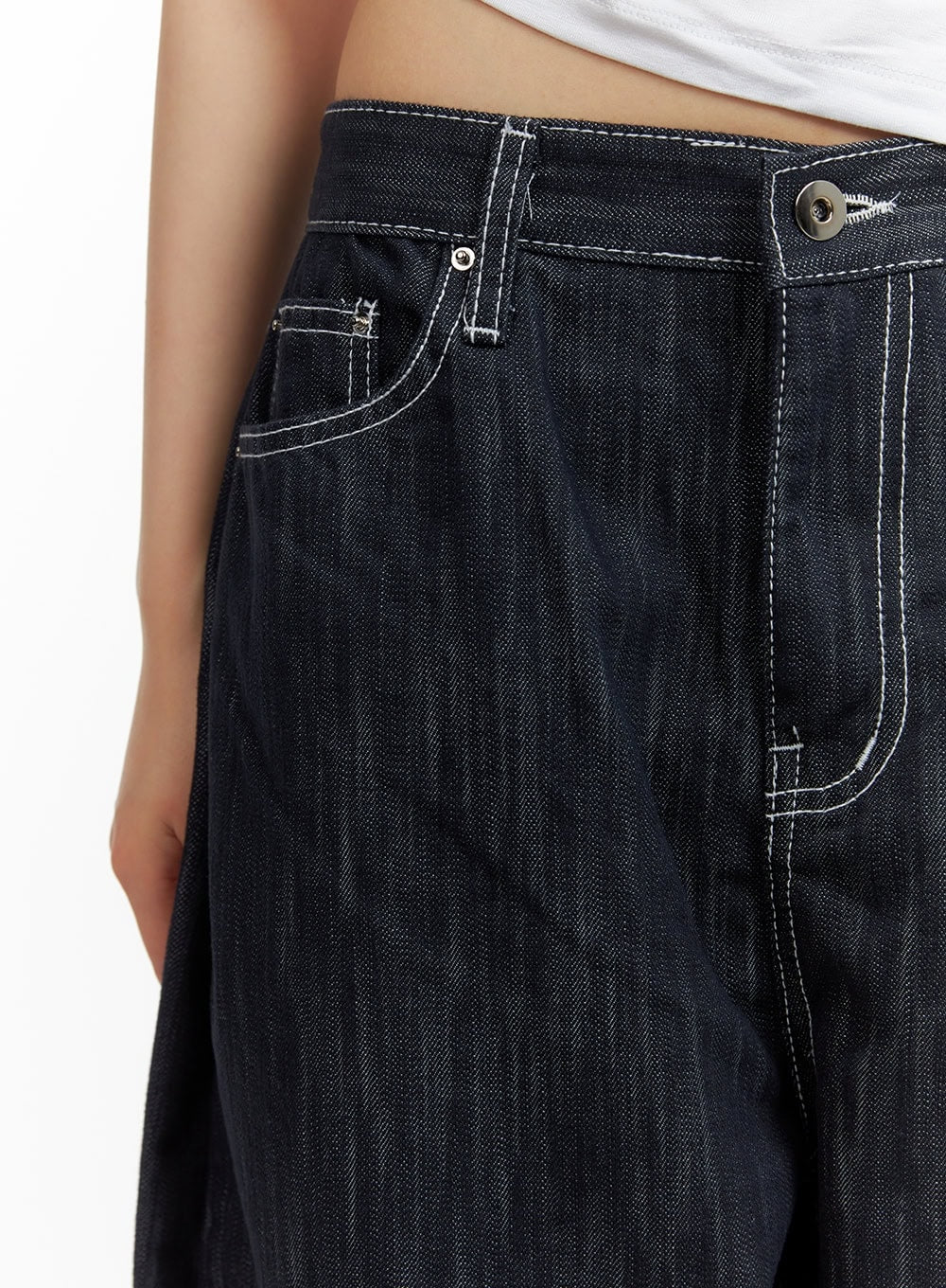Low-Rise Strap Baggy Jeans CY414 in dark blue, close-up of low-rise waistband and front pocket area showing silver button closure and contrast white topstitch detail.