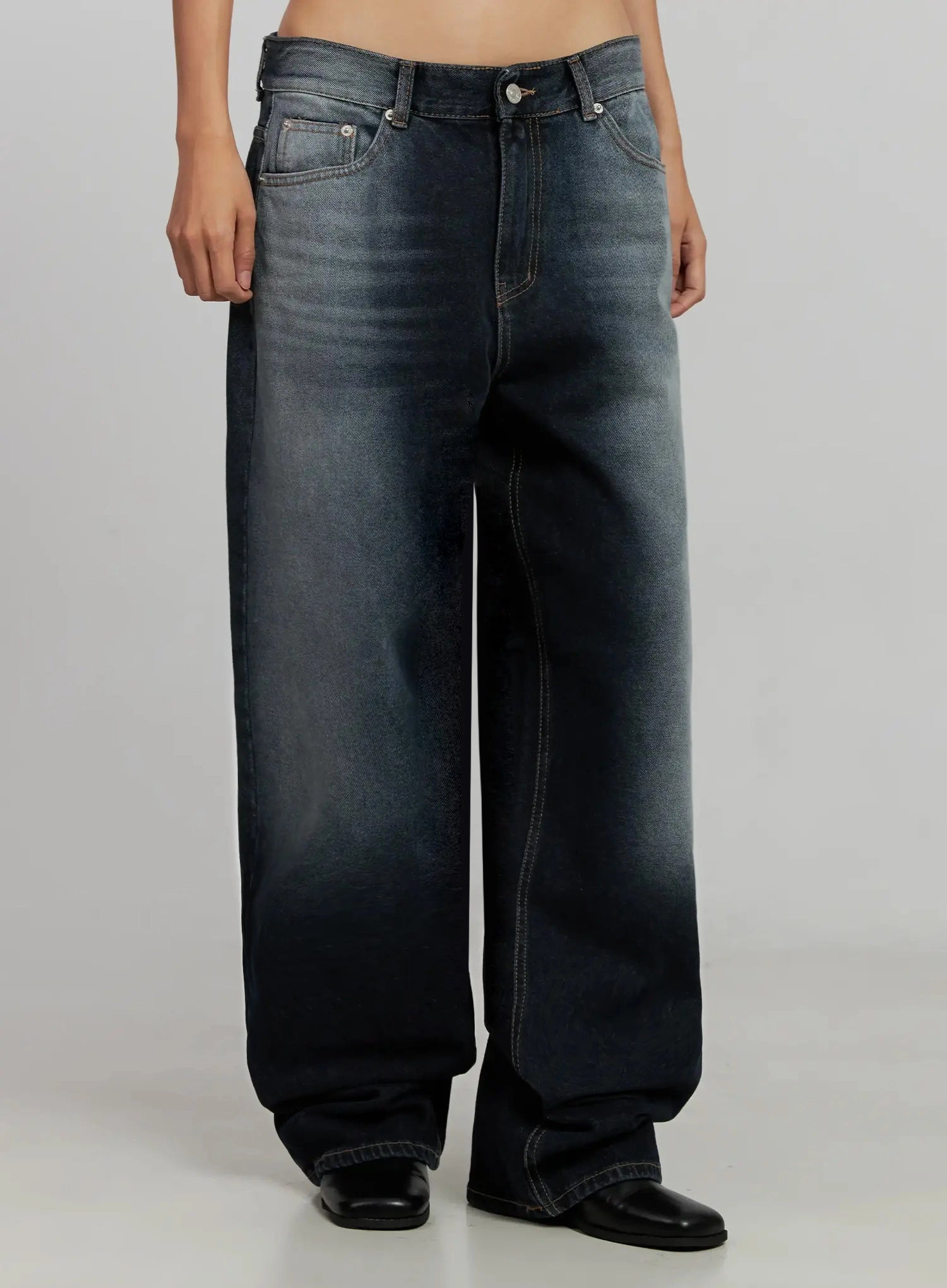 Chaya Washed Wide Jeans IJ505 in dark blue, front crop view on model, wide-leg low-rise cotton denim with lighter washed fade at hips and contrast topstitching, black boots.