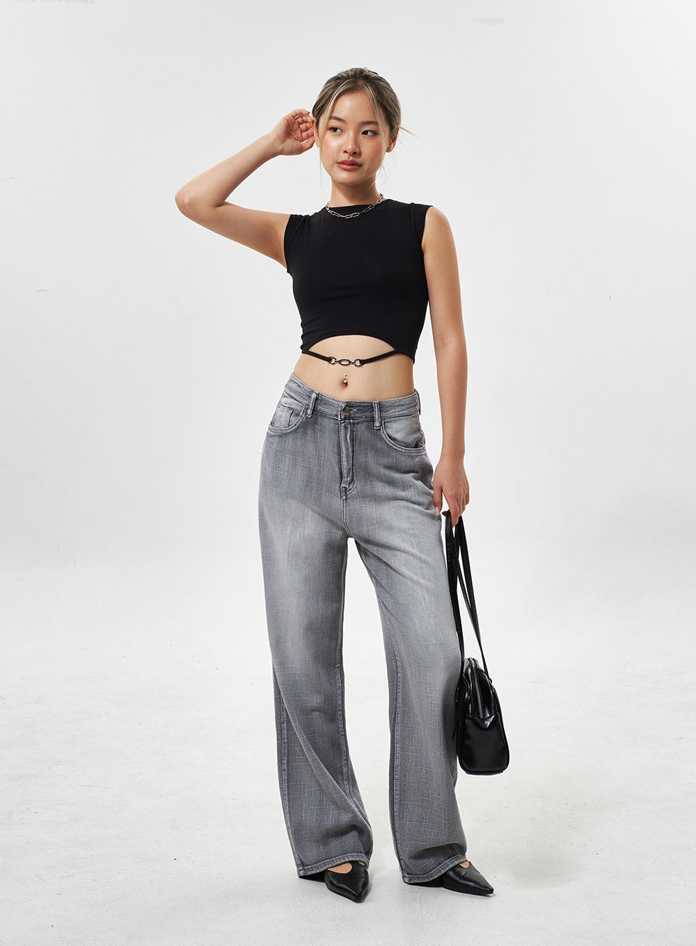 Mid-Rise Wide Leg Jeans CY330 in grey, full-length front shot on model with raised hand pose, wide-leg washed cotton denim, black crop top and bag.