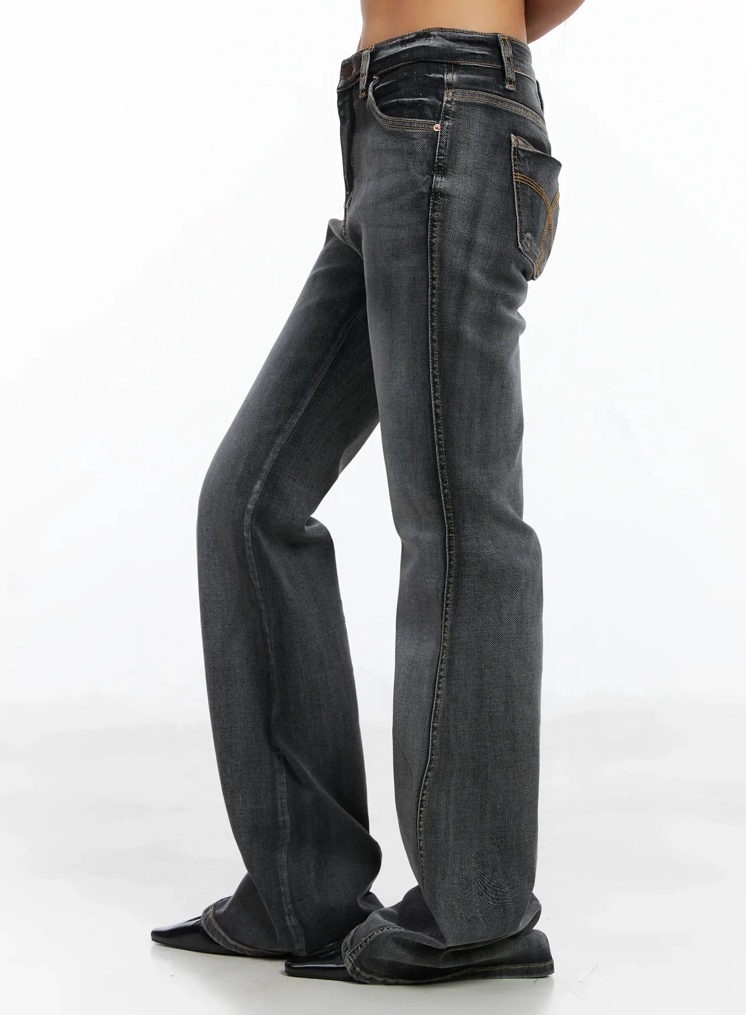 Phoe Flared Jeans ID503 in washed grey, rear three-quarter side view from waist to hem, showing back pocket embroidery detail and gradual bootcut flare on long inseam.