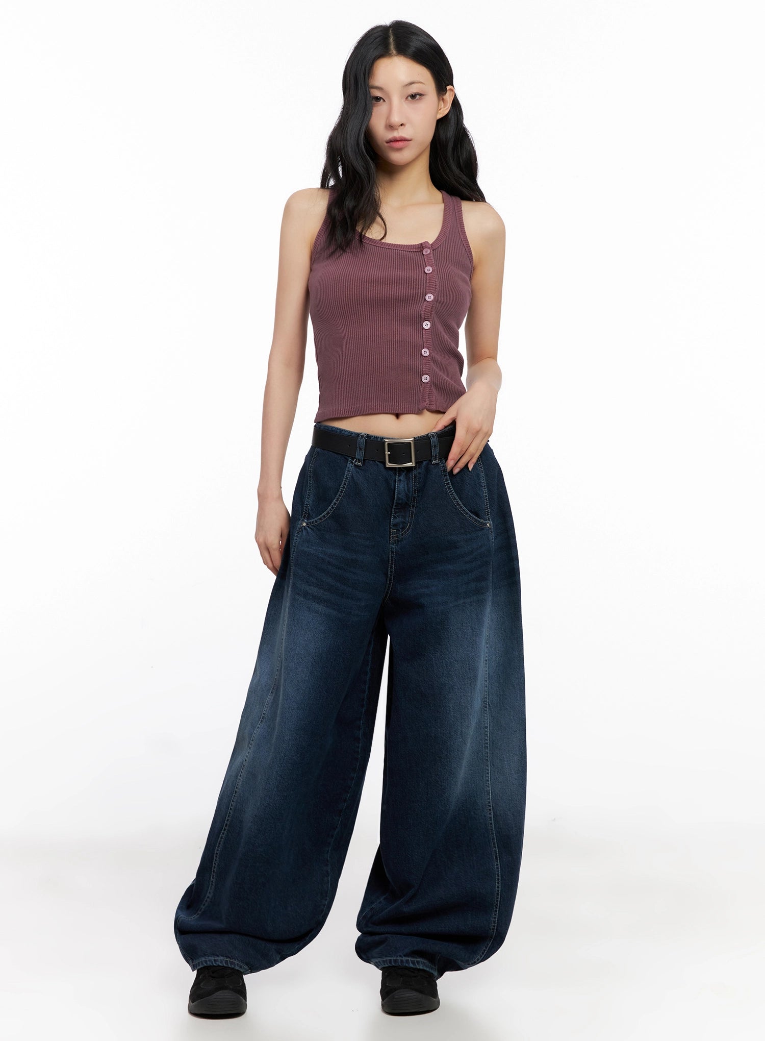 Sohee Angel Wing Print Wide-Leg Jeans IG508 in dark blue, full front view on model, oversized wide-leg washed denim with belt and front pockets, styled with mauve ribbed crop tank and black sneakers.