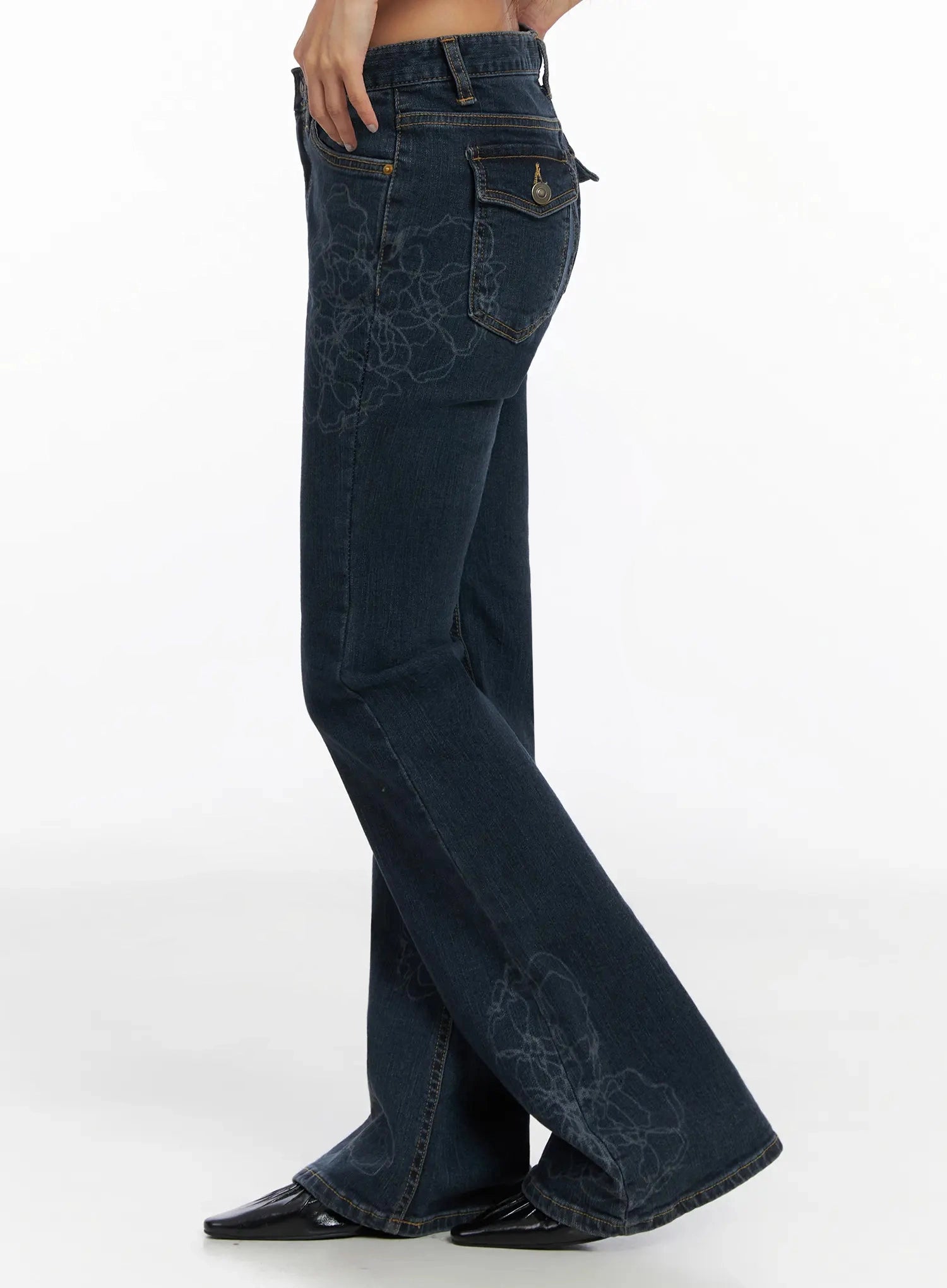 Amari Floral Embriodered Bootcut Jeans IN528 in dark blue, side shot waist to hem on model, revealing flap back pocket with snap button, floral embroidery on outer leg, gradual bootcut flare hem.