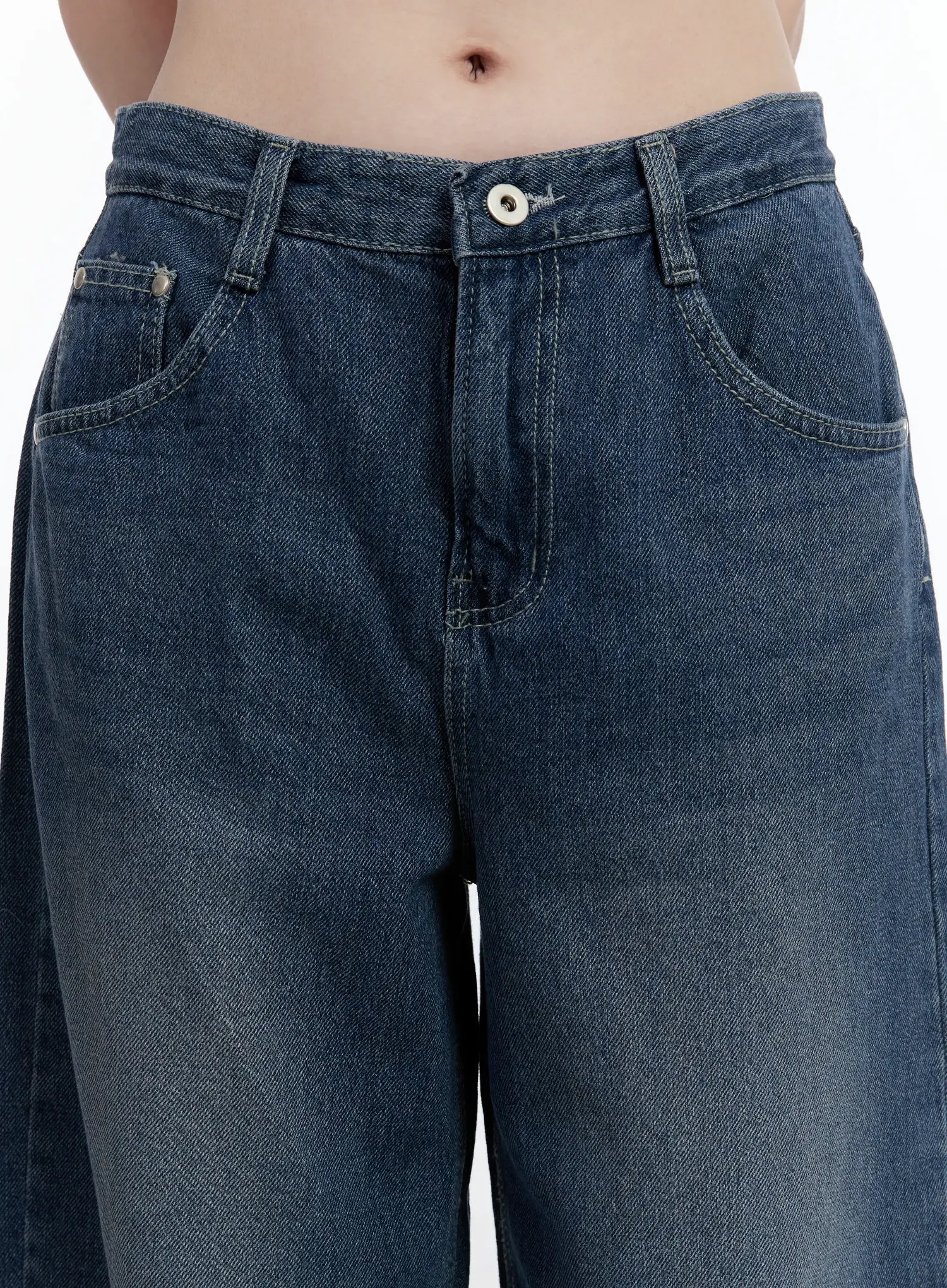 Della Casual Denim Wide Jeans ID511 in blue, close-up front waist detail shot on model, button closure, front pockets, and washed denim texture clearly visible.