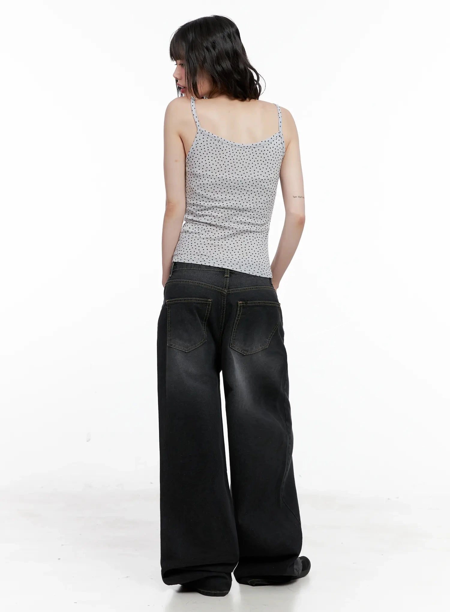 IU Vintage Black Baggy Jeans IL528 in black, back full-length shot on model, two back patch pockets with contrast stitching, washed cotton wide leg, pooling at hem.