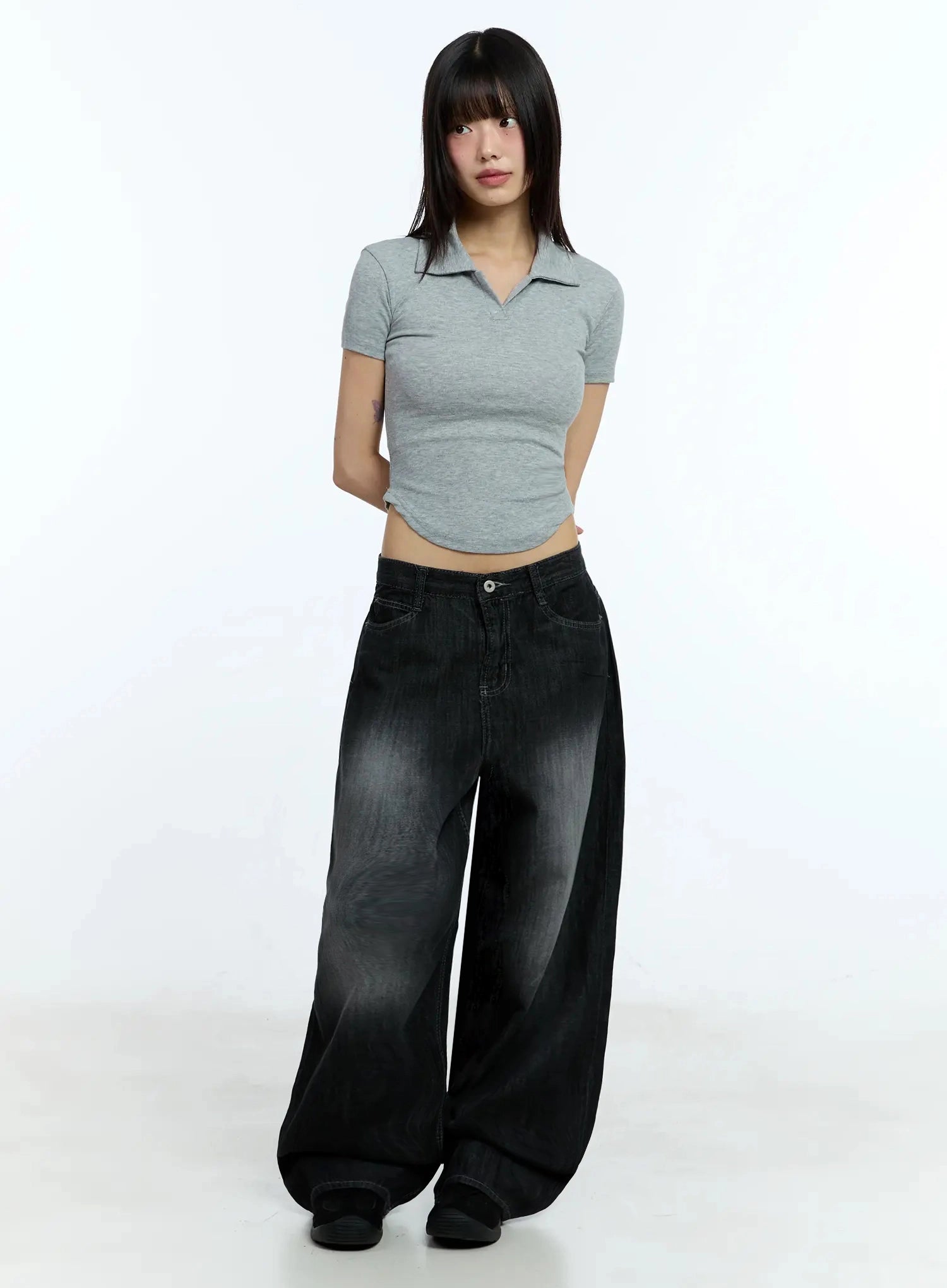 Wendy Washed Wide-Leg Jeans IU524 in black, full-body front shot on model, washed fading from thigh to hem, wide-leg cotton denim, paired with grey ribbed polo crop top.