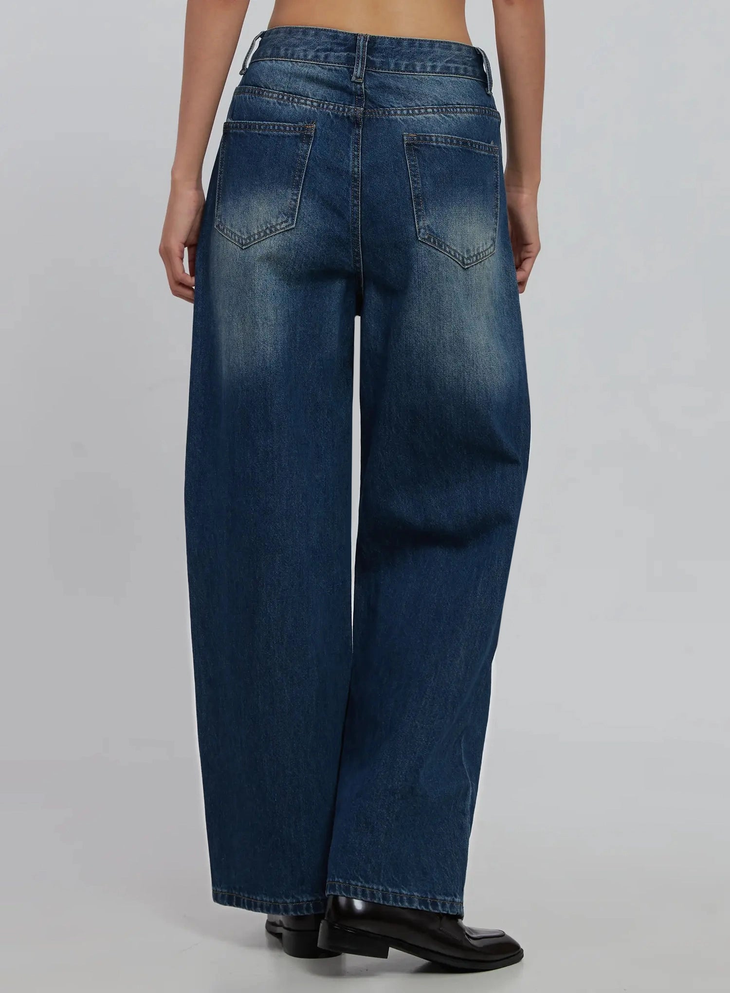 Alaina Wide Leg Jeans IJ508 in dark blue, back crop view on model, two back patch pockets with contrast topstitching, washed fade detail, wide hem at ankle.