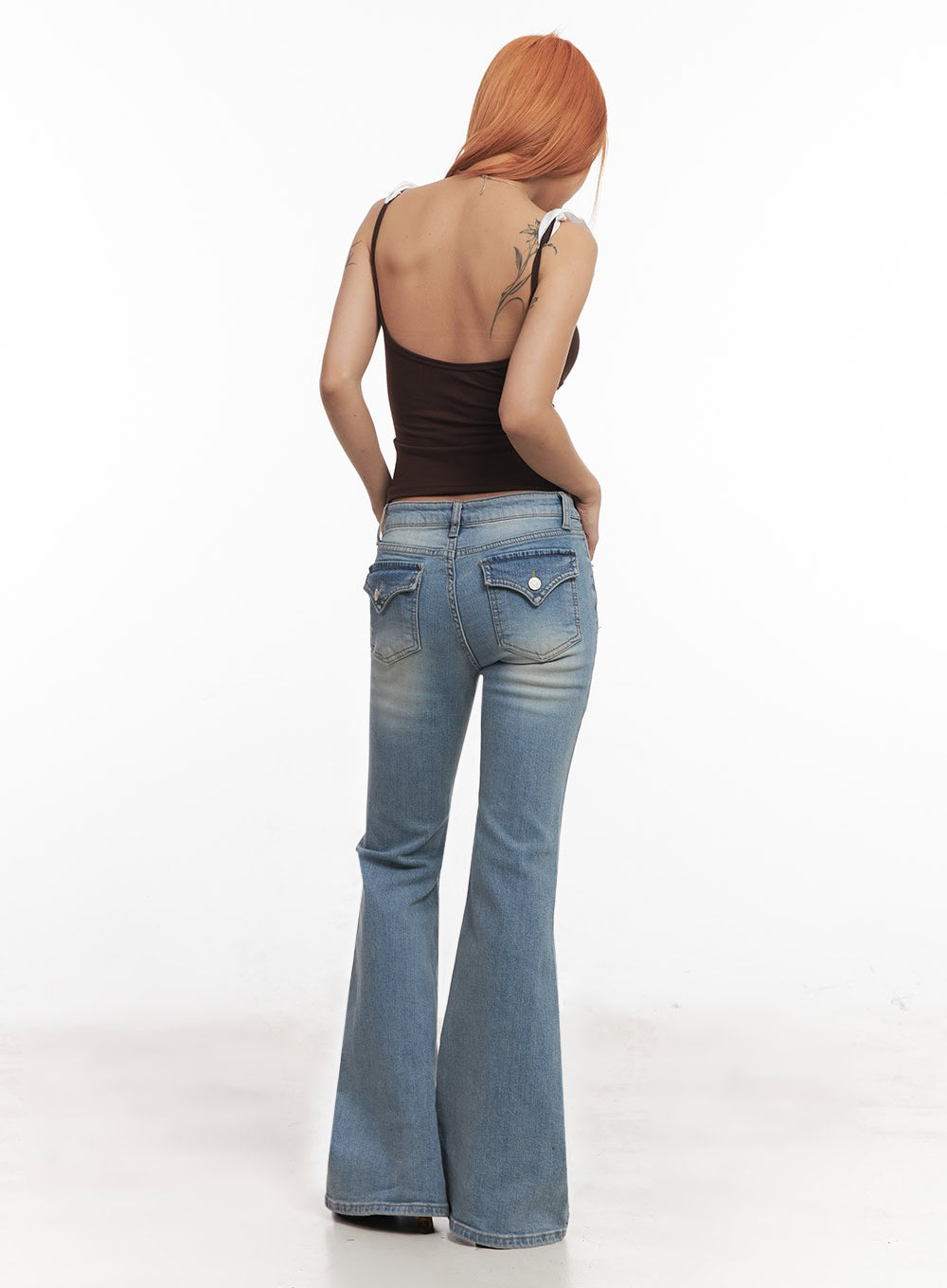 May Washed Flared Jeans IA515 in light blue, full back view on model, back flap pockets with snap buttons, washed slim-fit denim flaring at calf, paired with brown ruffle crop top.